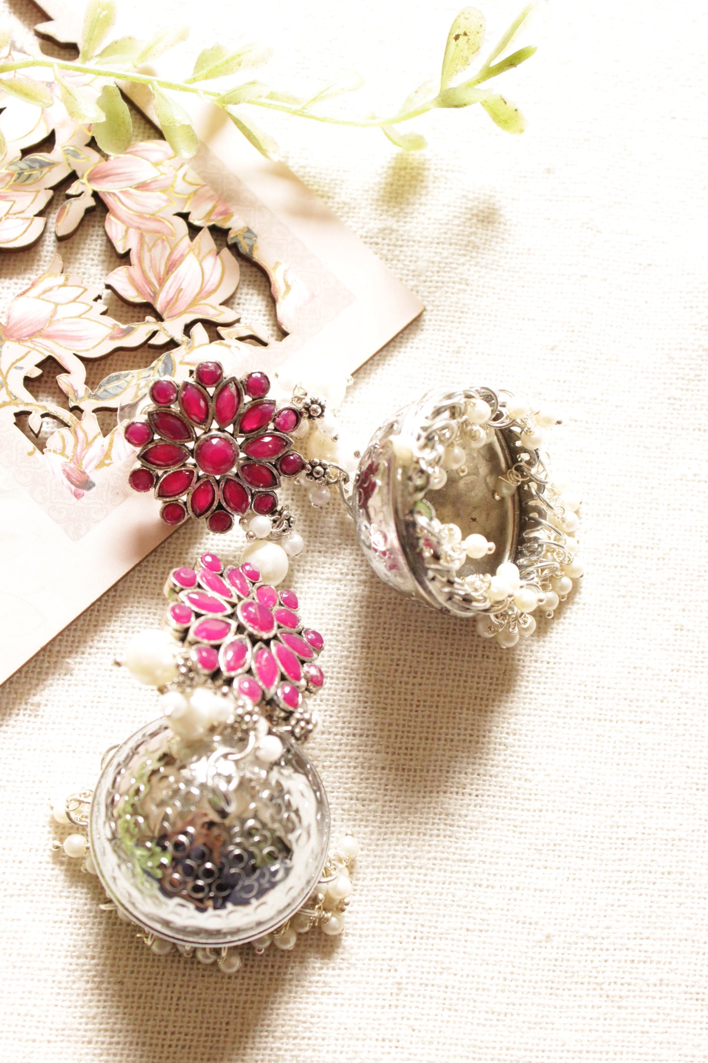 Red Glass Stones Embedded Silver Finish Jhumka Earrings