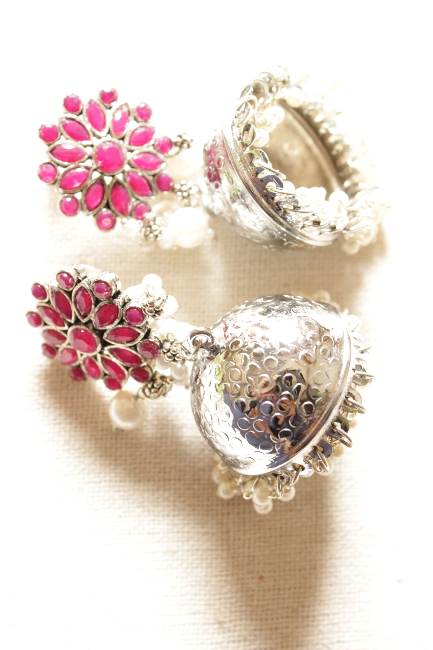 Red Glass Stones Embedded Silver Finish Jhumka Earrings