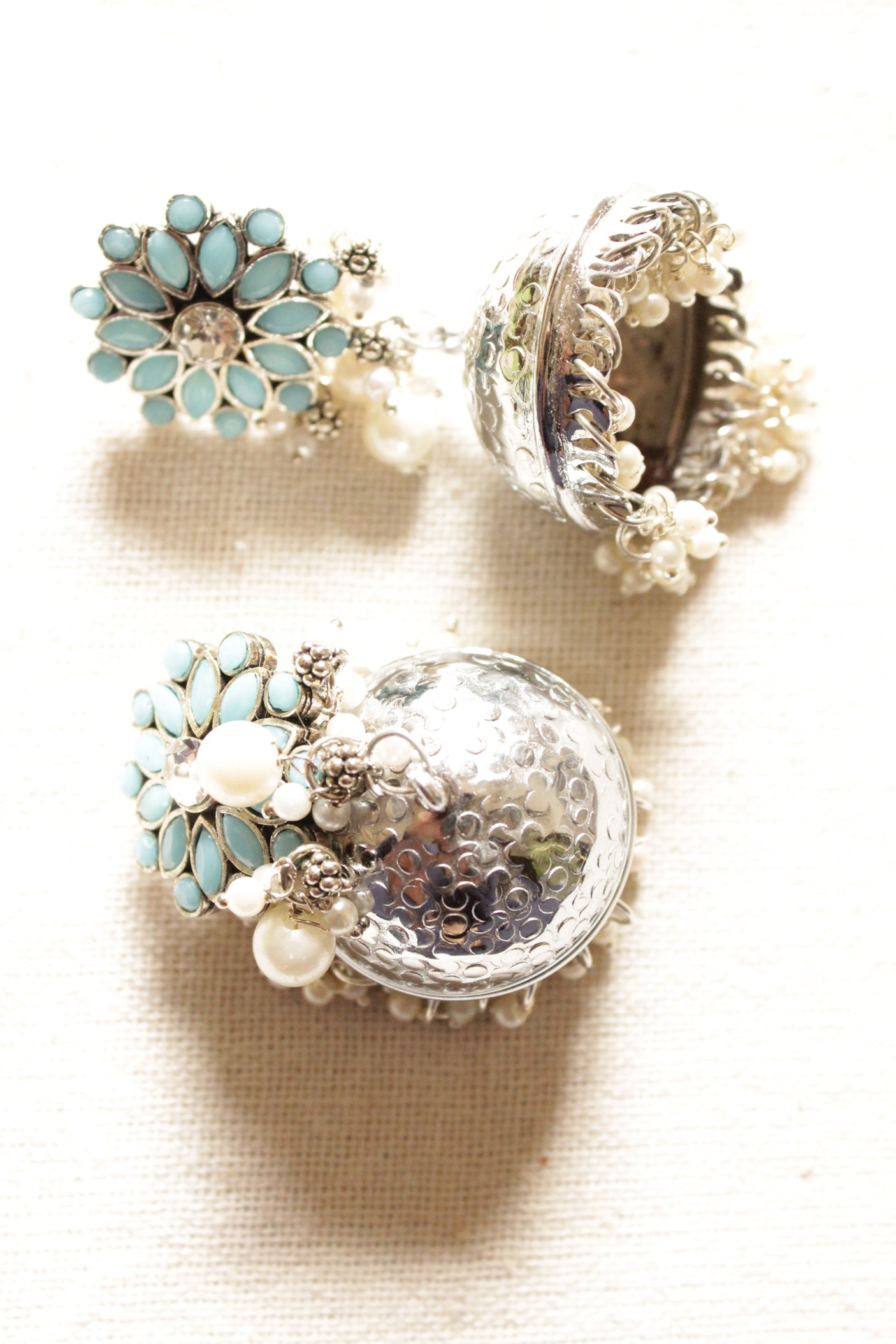 Turquoise Glass Stones Embedded Silver Finish Jhumka Earrings