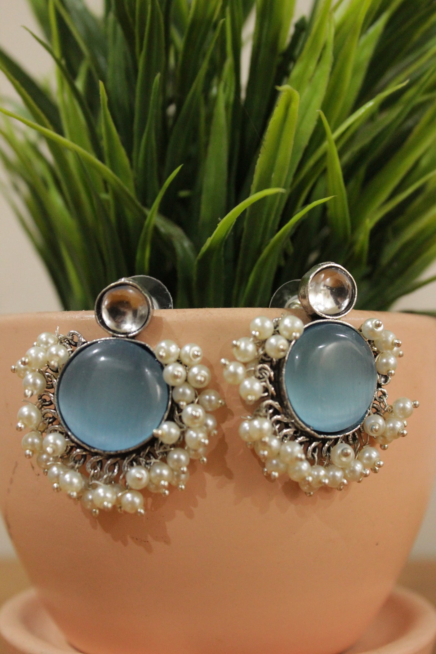Blue Glass Stone Embedded Oxidised Finish Circular Brass Earrings Embellished with White Beads