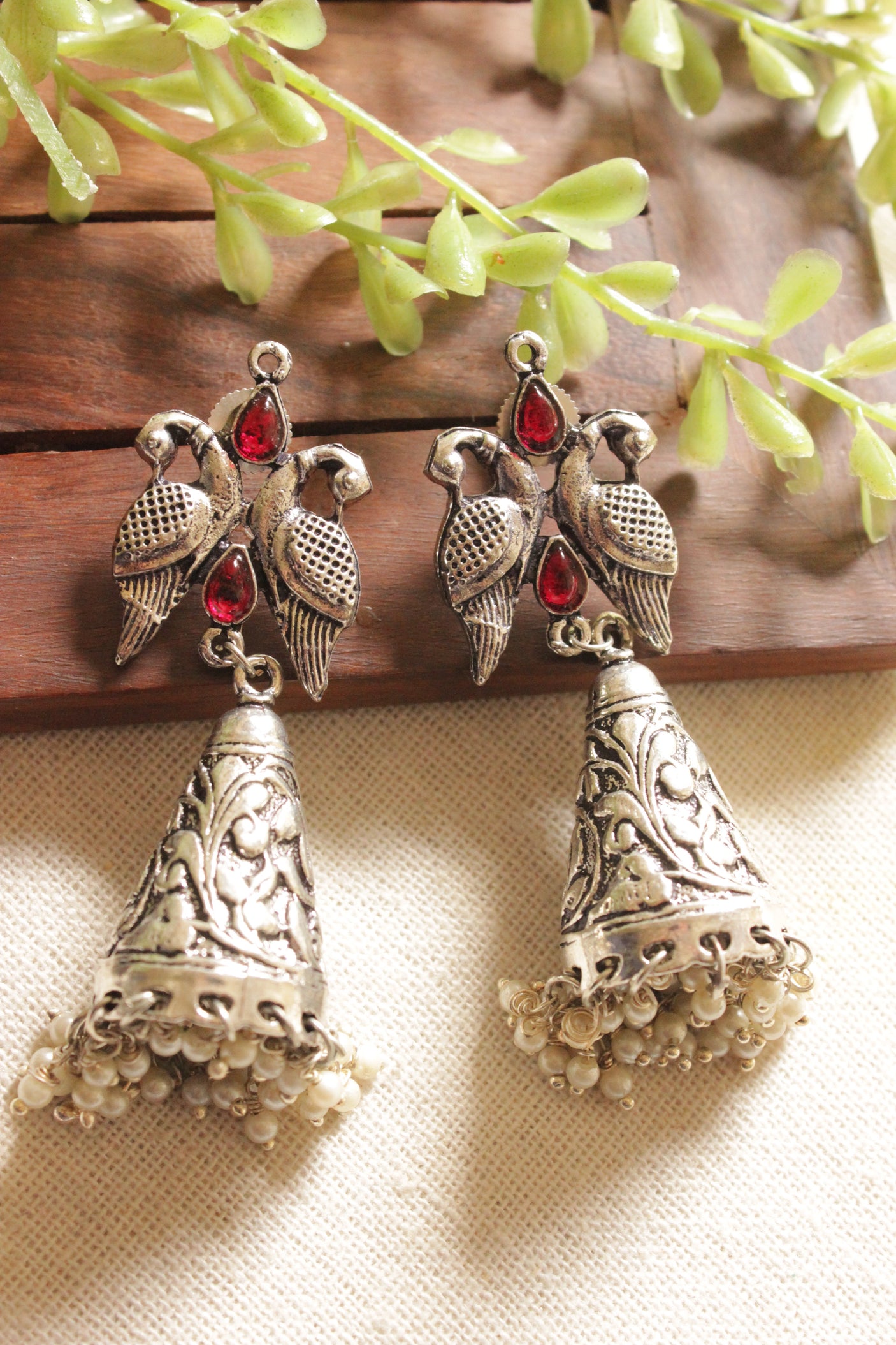 Red Glass Stones Embedded Oxidised Finish Bird Dangler Earrings
