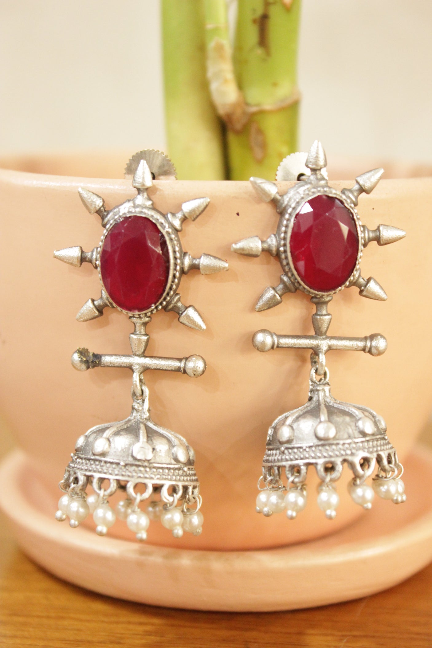 Ruby Red Gemstone Embedded Warrior Motif Silver Finish Brass Jhumka Earrings