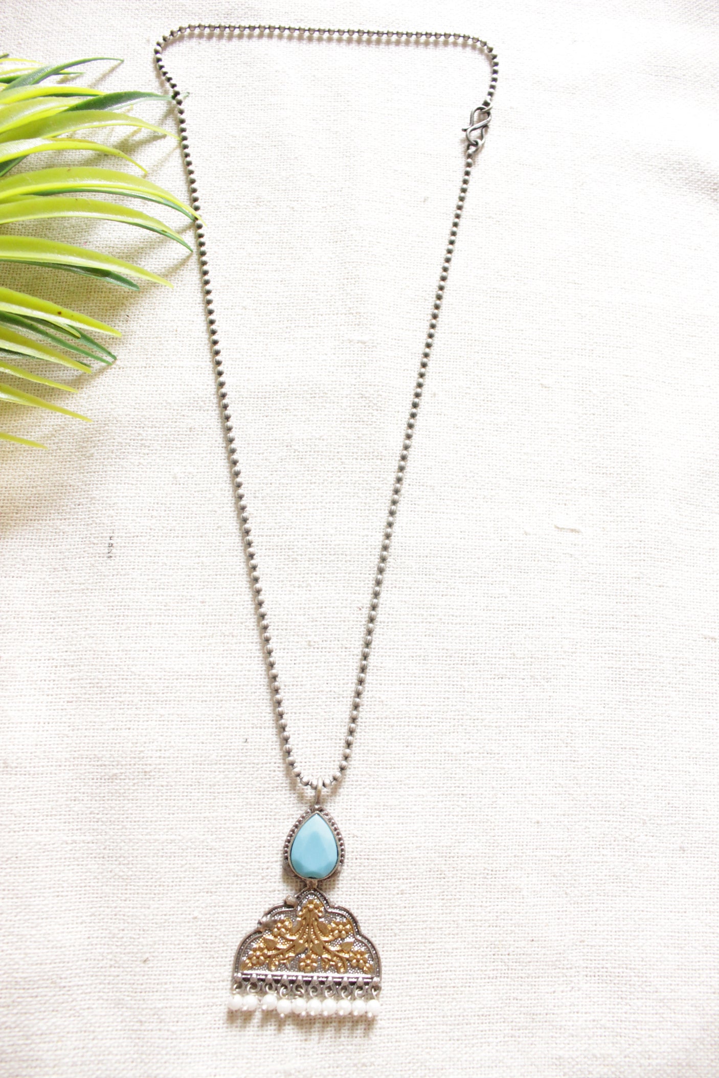 Dual Tone Pendant with Embossed Flowers and Leaves Petite Beaded Silver Chain Oxidised Finish Necklace Embellished with Blue Stone