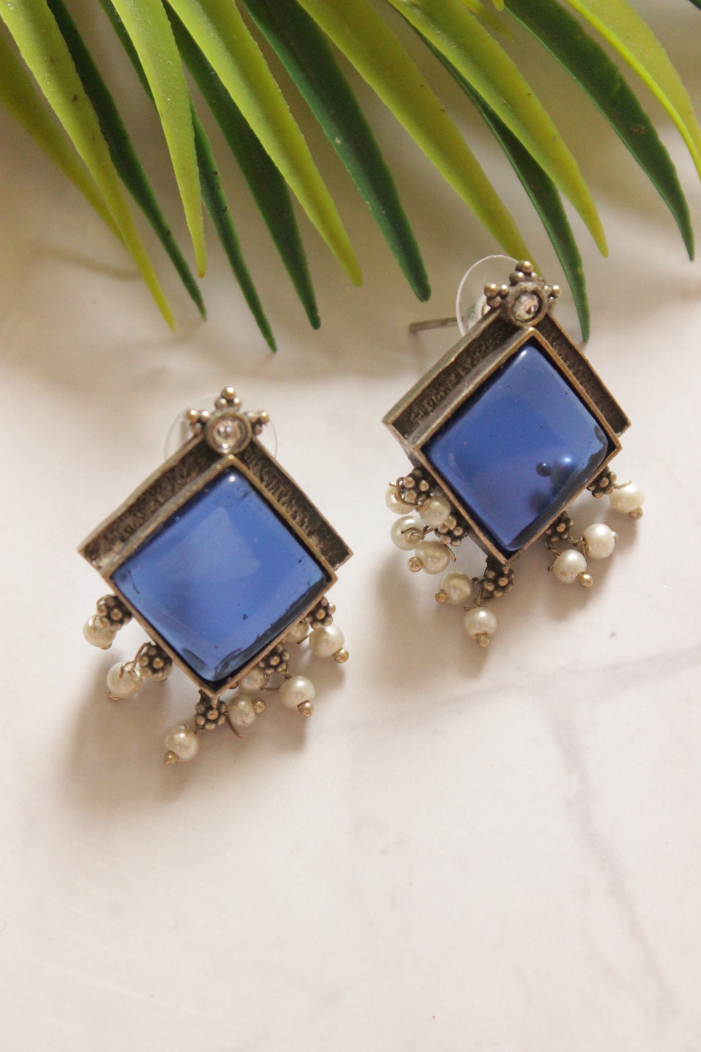 Premium Oxidised Finish Blue Center Stone Embedded White Pearl Embellished Stud Earrings