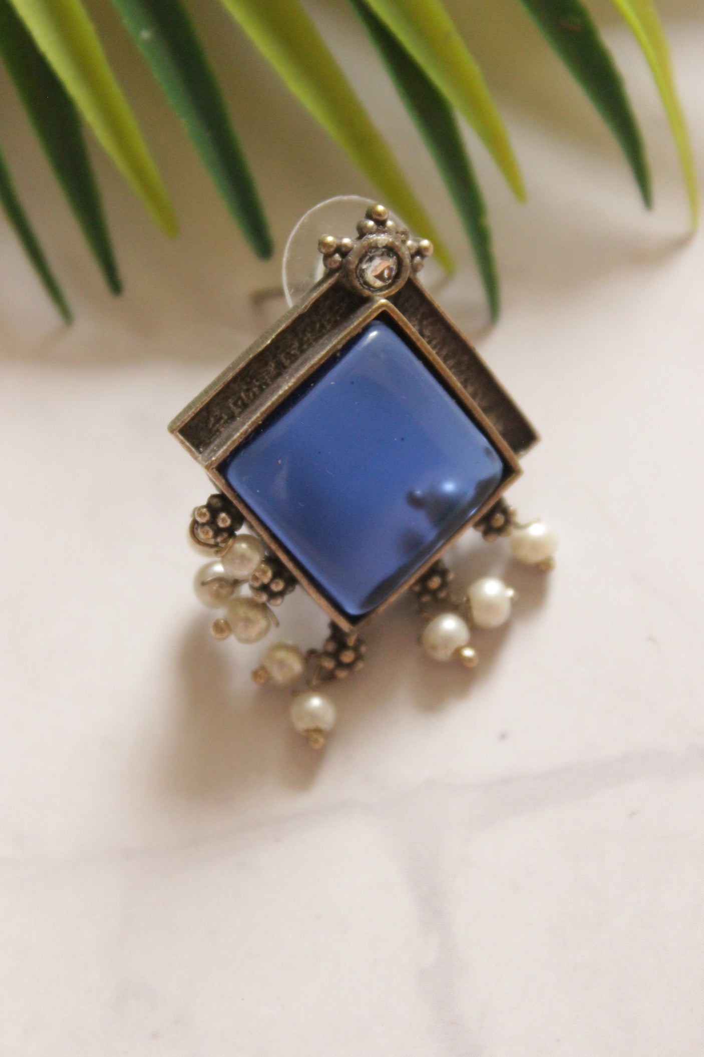 Premium Oxidised Finish Blue Center Stone Embedded White Pearl Embellished Stud Earrings