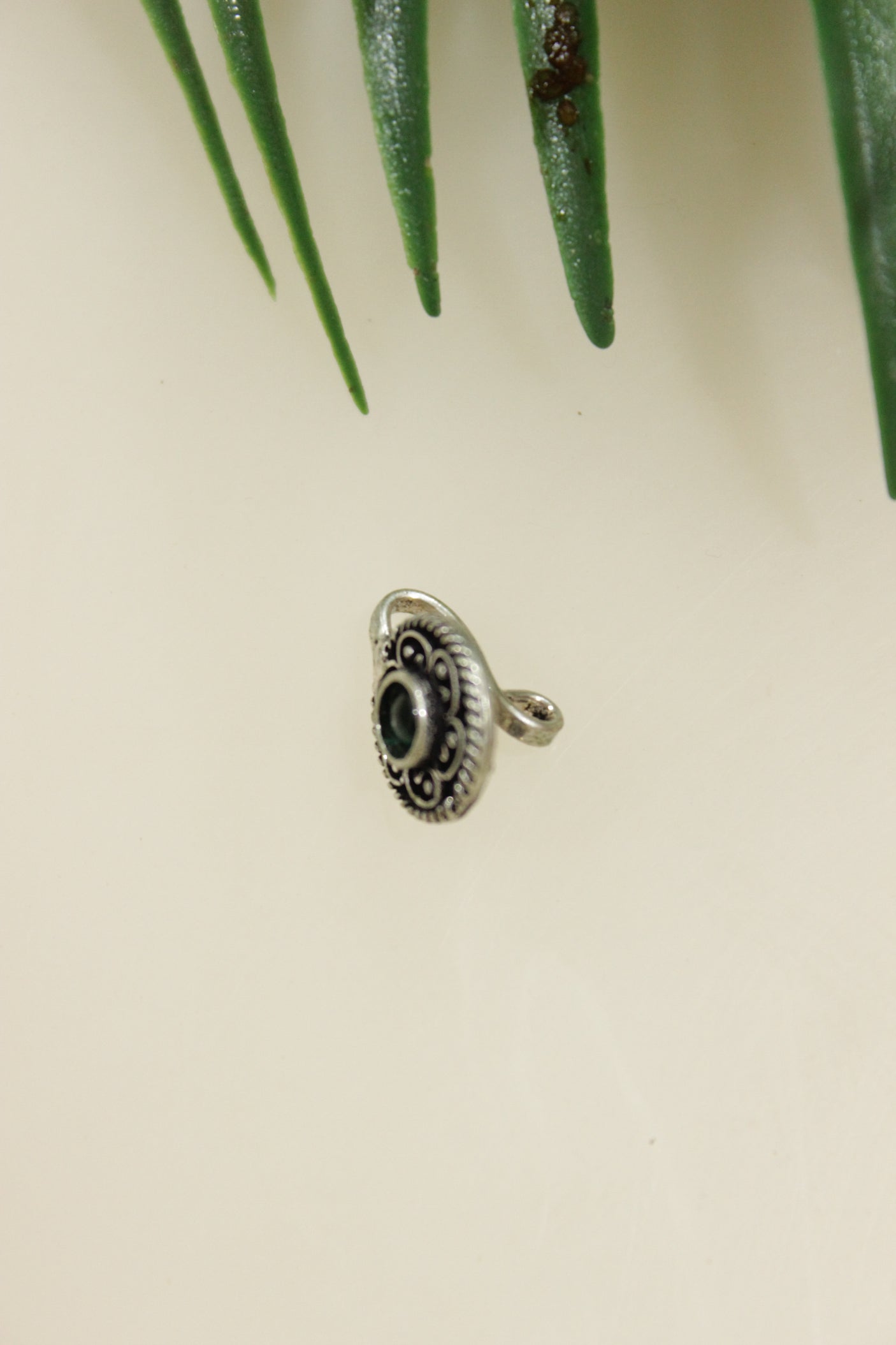 Green Center Stone Embedded Oxidised Finish Circular Clip On Nosepin