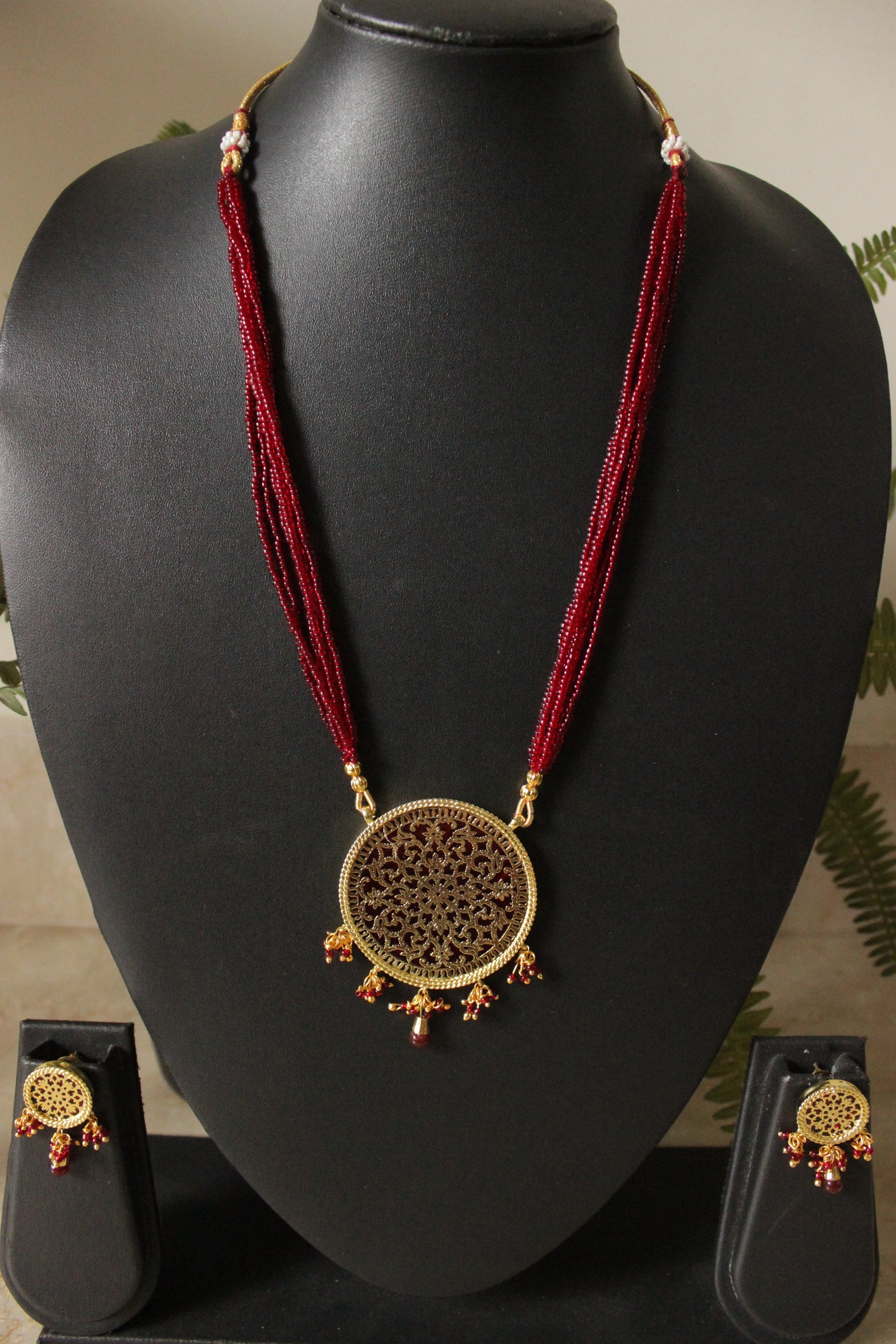 Intricately Detailed Gold Toned Pendant Necklace Set with Multi-Layer Red Beads Closure