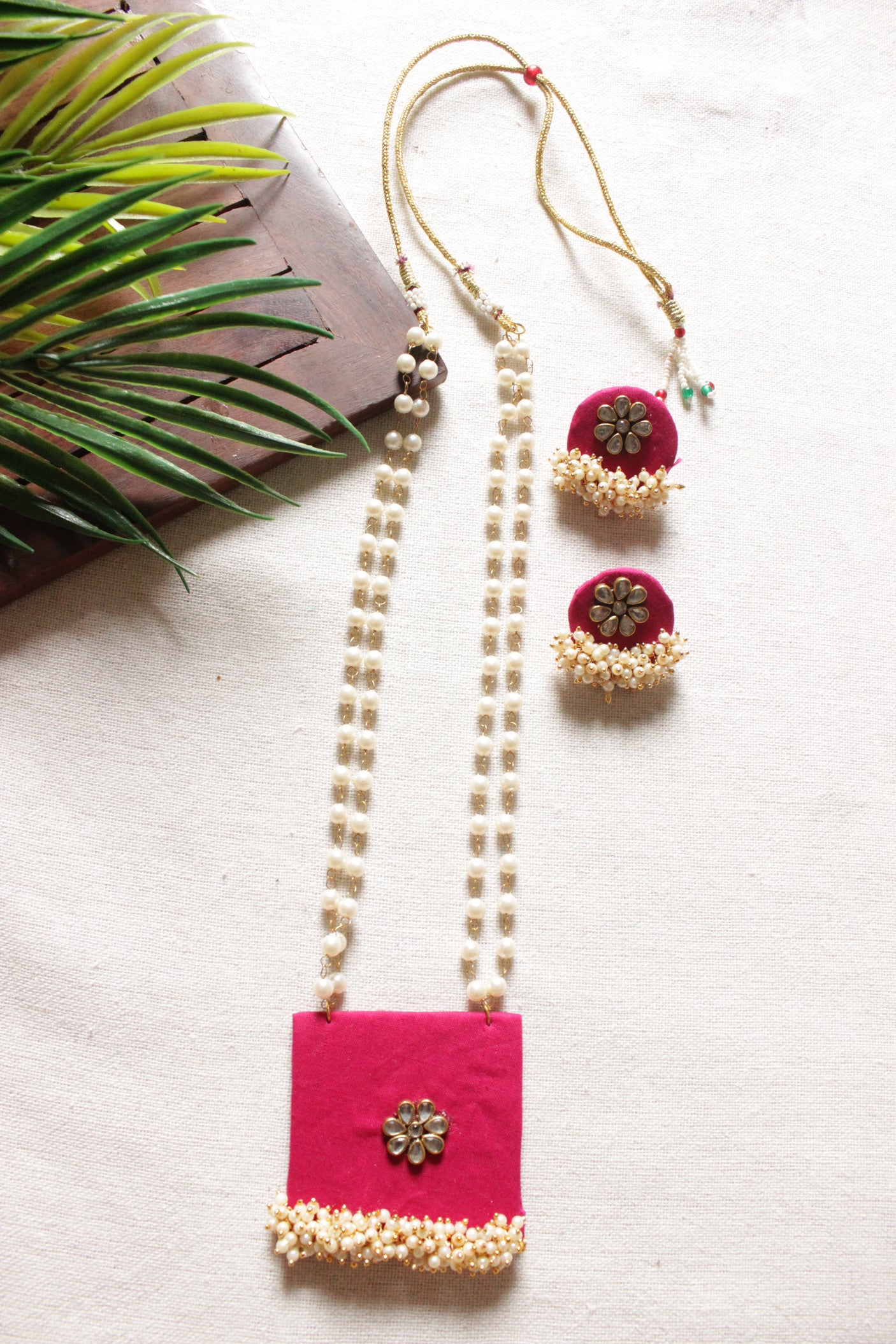 Fuchsia Fabric Gold Toned Necklace Set Embellished with Kundan Stones and Pearls