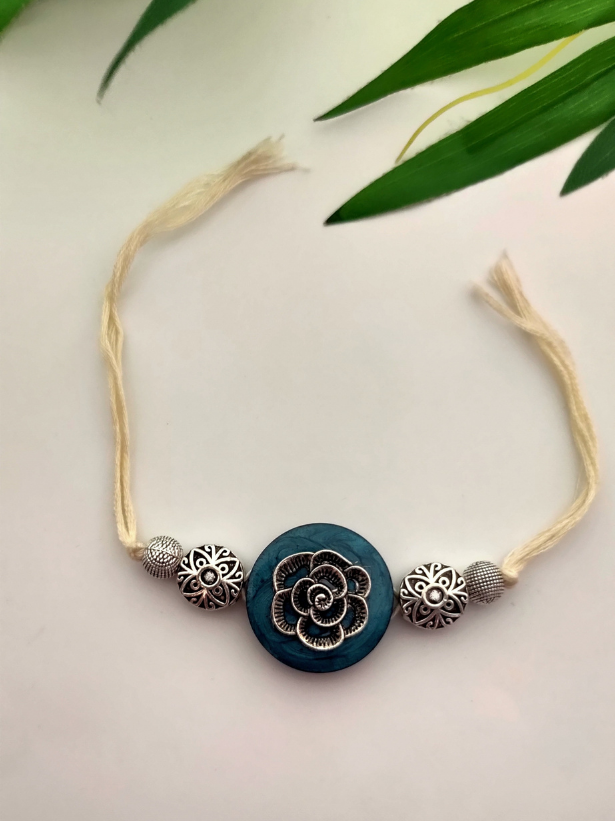 Intricately Detailed Blue Wood and Metal Rakhi with Off-White Cotton Thread