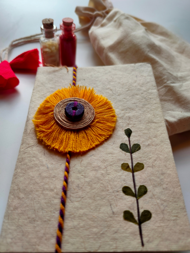 Eco-Friendly Handmade Jute & Thread Flower Rakhi with Dried Leaves and Flower Petals (Comes with a Reusable Cloth Pouch and Recycled Paper Card)