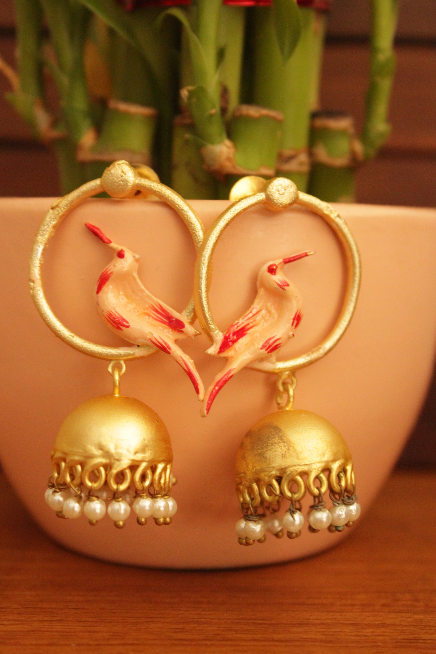 Bird Motif Hand Painted Gold Toned Handmade Brass Hoop Jhumka Earrings Accentuated with White Beads