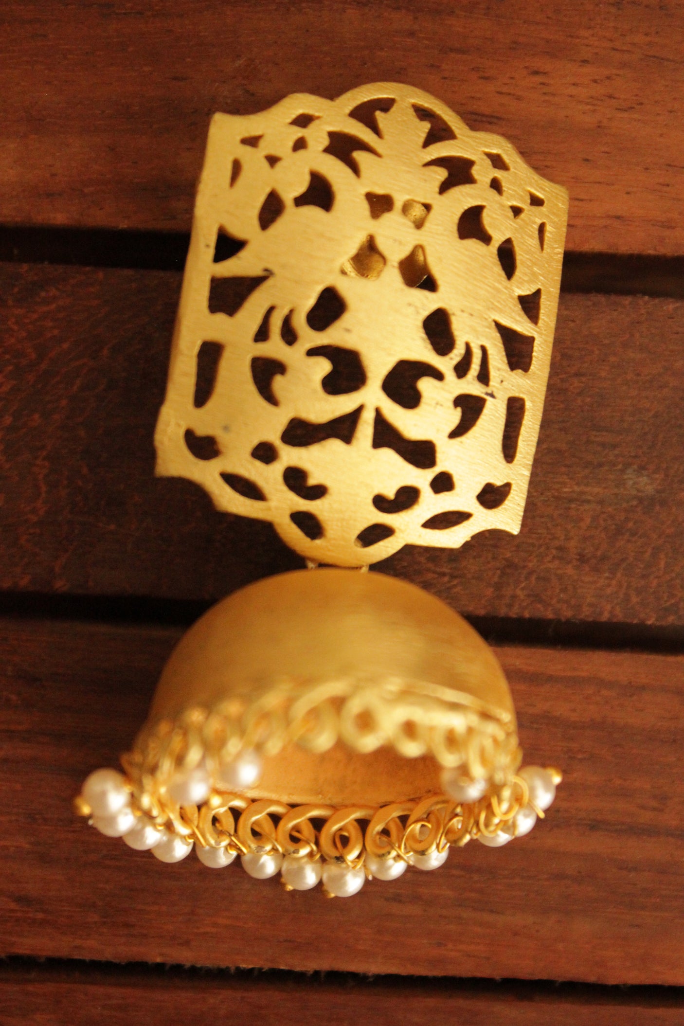 Jaali Pattern Gold Toned Handmade Jhumka Earrings Accentuated with White Beads