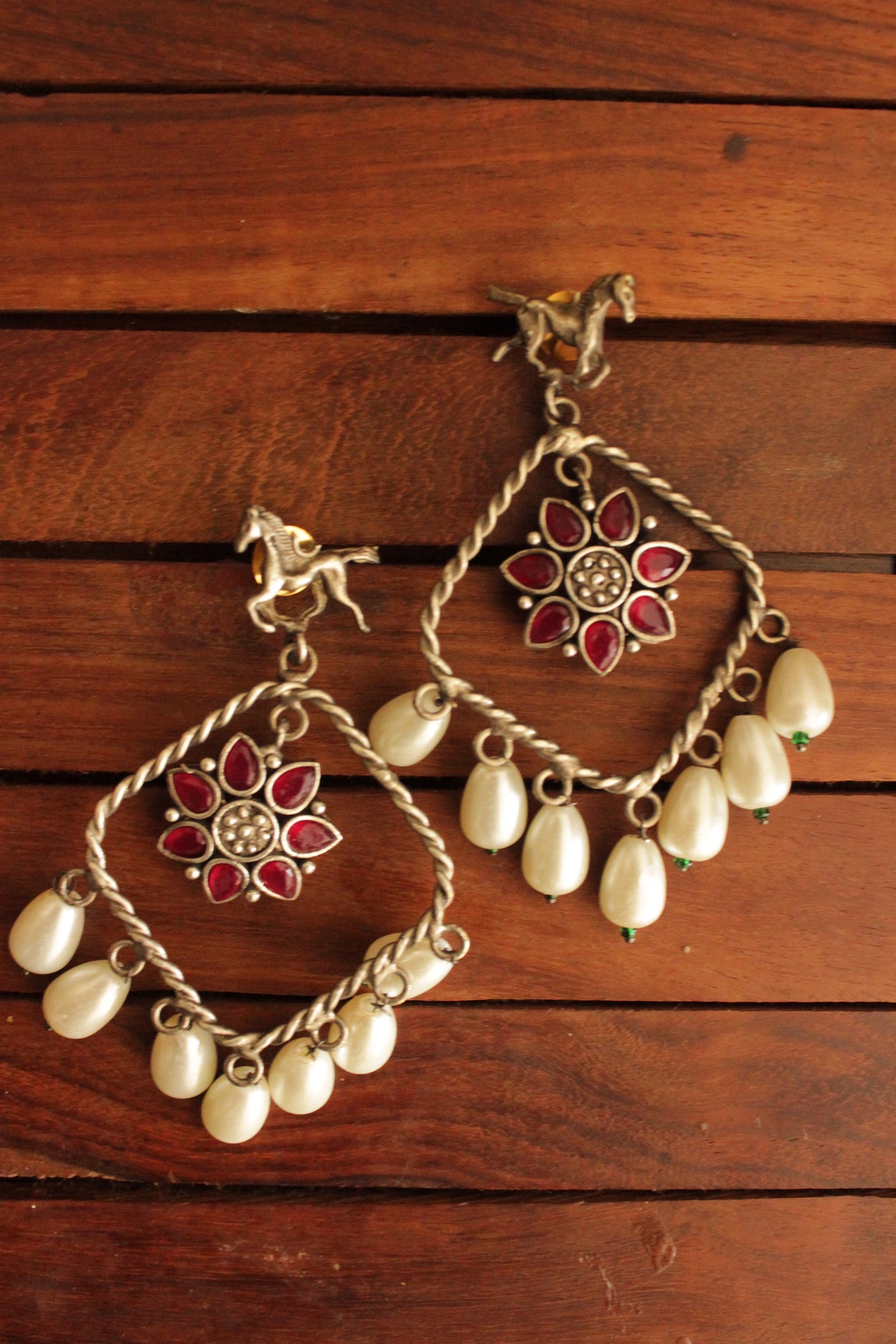 Horse Motif Ruby Stone Embedded Oxidised Finish Brass Earrings Accentuated with White Pearl Danglers