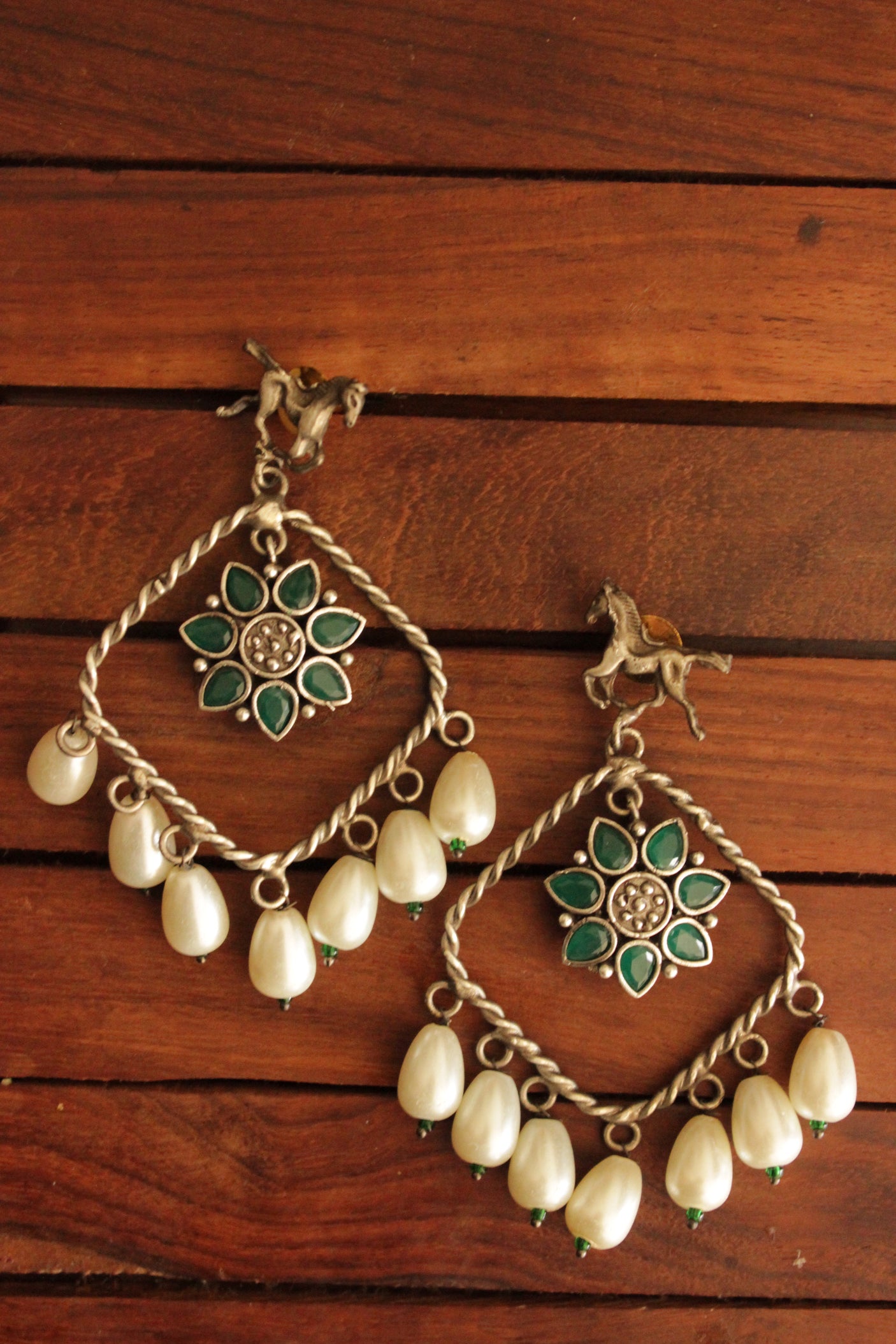 Horse Motif Green Stone Embedded Oxidised Finish Brass Earrings Accentuated with White Pearl Danglers
