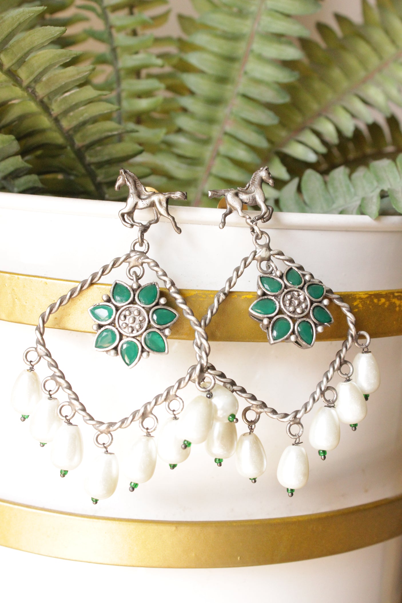 Horse Motif Green Stone Embedded Oxidised Finish Brass Earrings Accentuated with White Pearl Danglers