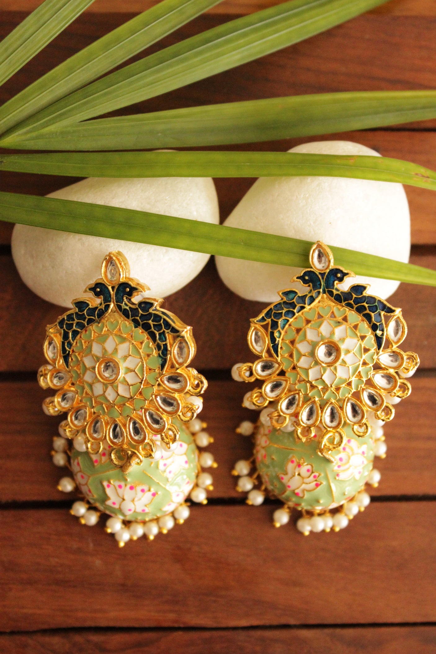 Elaborate Kundan Stones Embedded Gold Toned Hand Painted Peacock Motifs Mint Green Meenakari Jhumka Earrrings