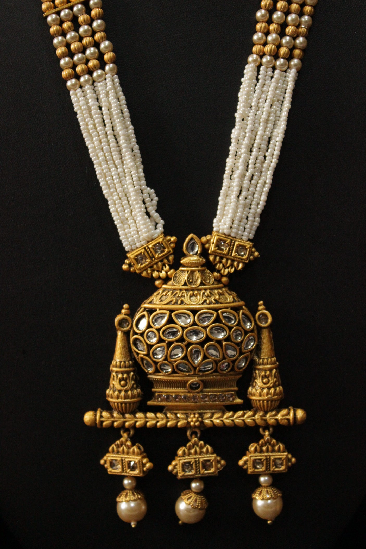 Kundan Stones Embedded Kalash Motif Matt Gold Finish Multi-Layer White Beads Long Necklace Set with Jhumka Earrings