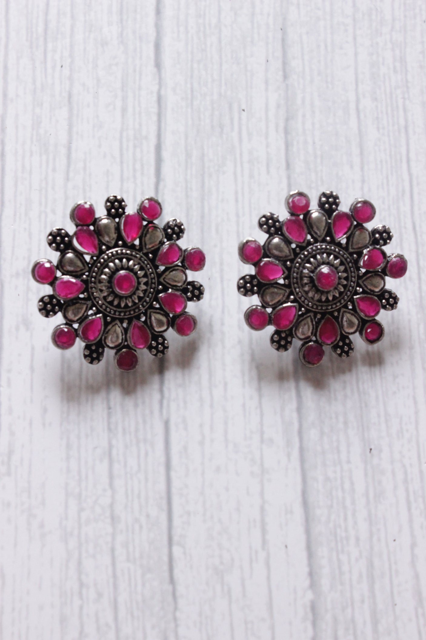 Red Stones Embedded Oxidised Silver Finish Statement Stud Earrings