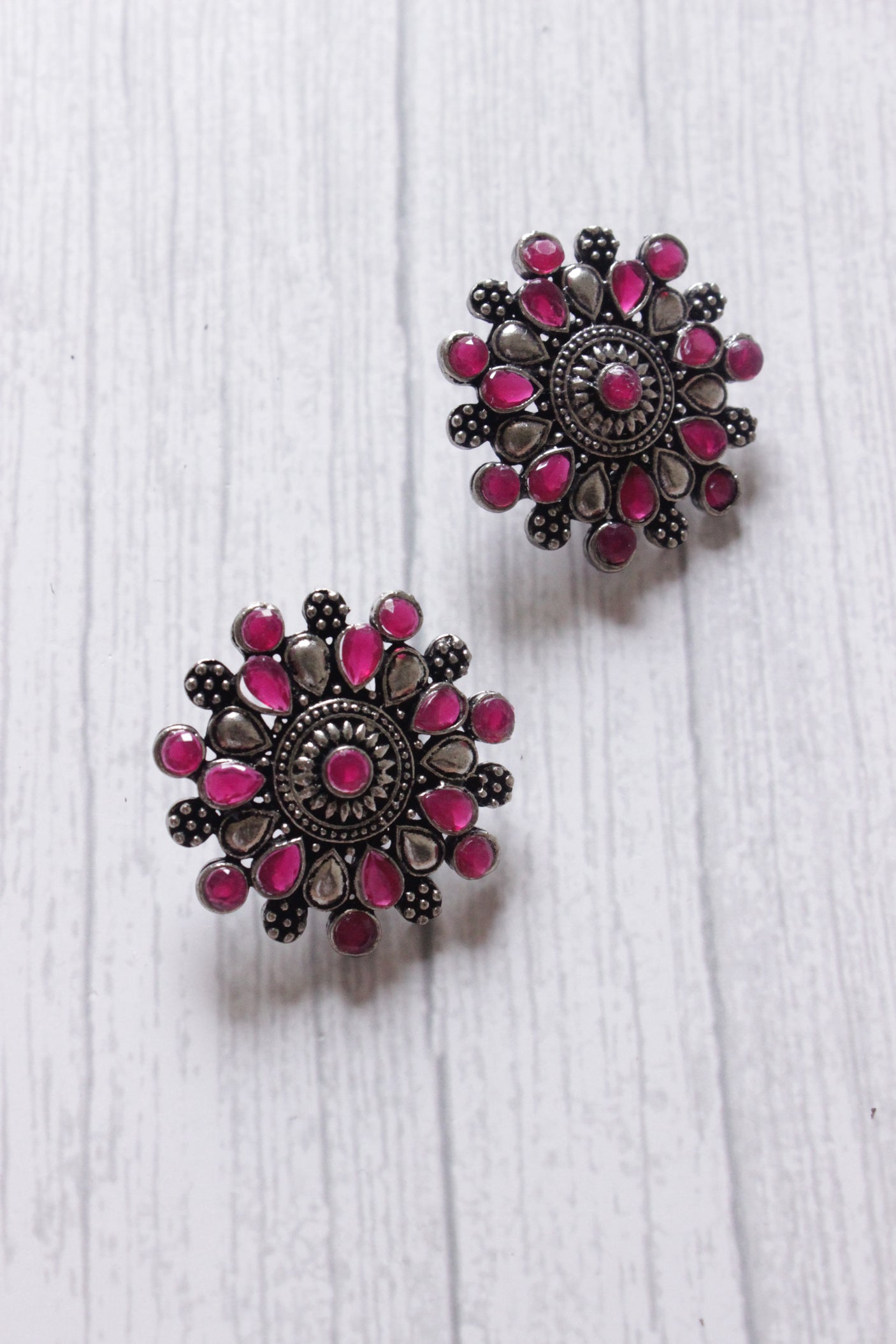 Red Stones Embedded Oxidised Silver Finish Statement Stud Earrings