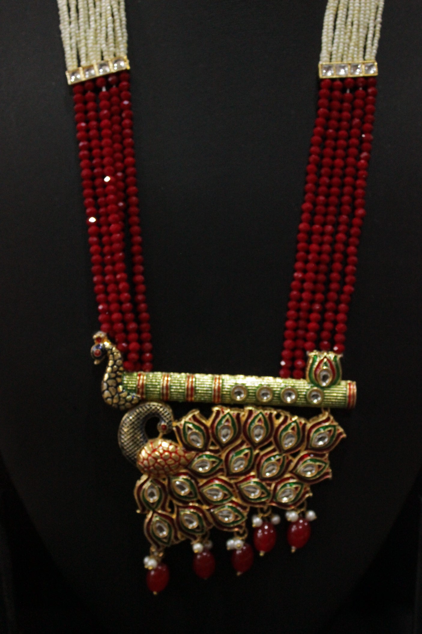 Kundan Stones Embedded Enamel Painted Peacock and Bansuri Motif Pendant Multi-Layer Red Beads Necklace Set