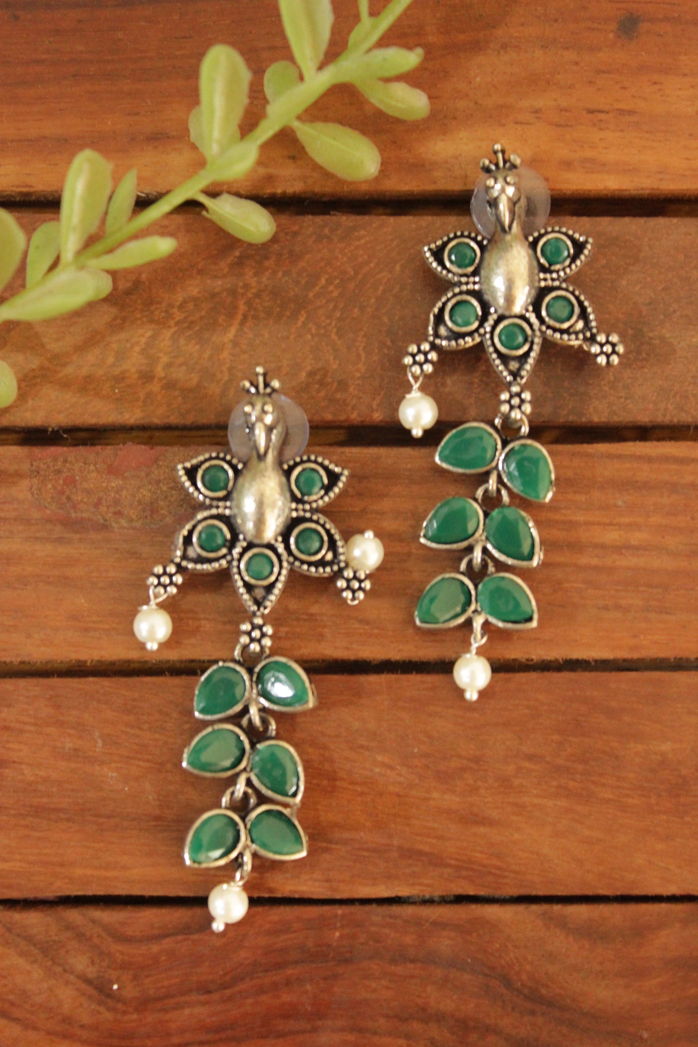 Peacock Motif Oxidised Finish Dangler Earrings Embedded with Green Stones
