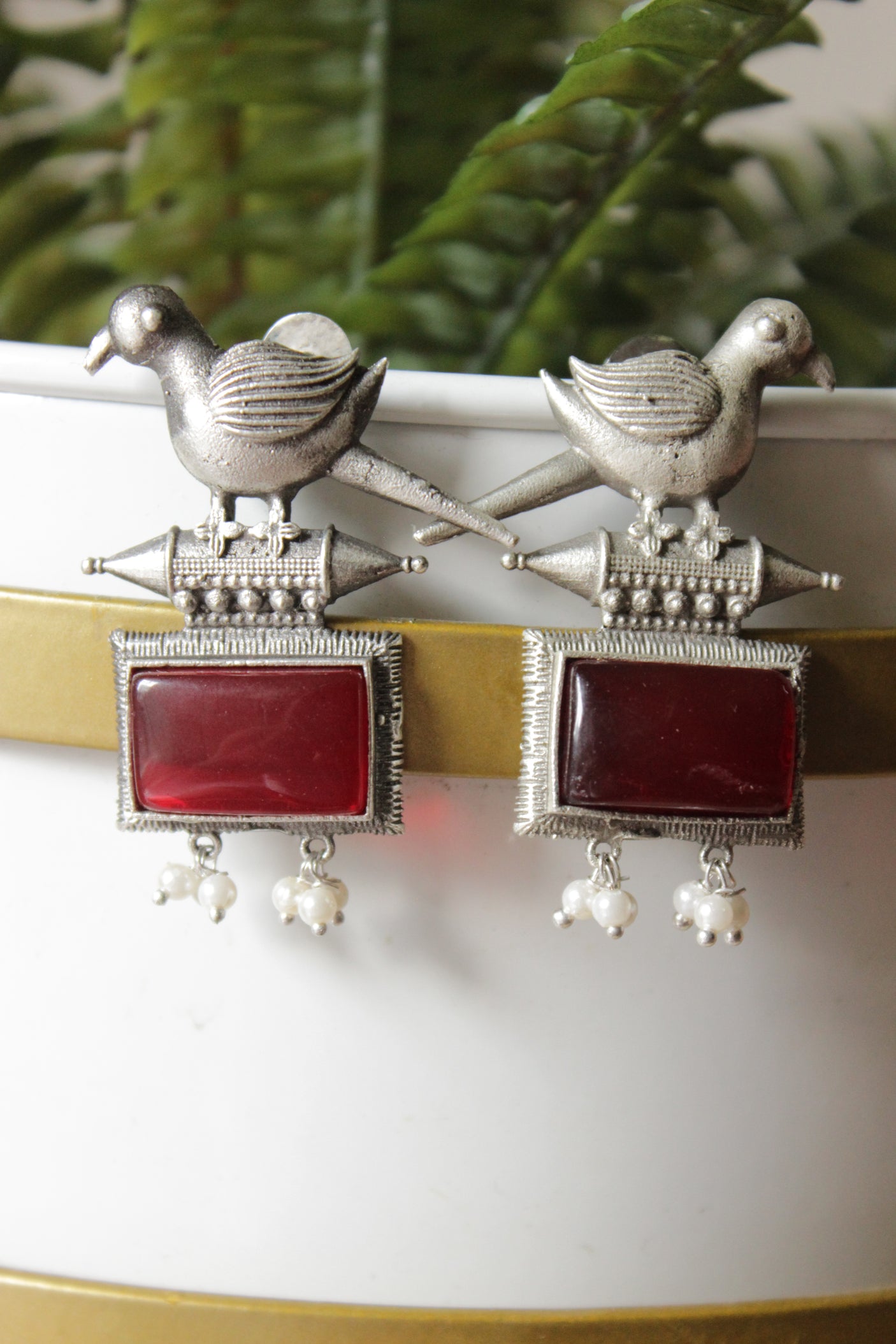 Peacock Motif Ruby Red Glass Stone Embedded Silver Finish Brass Dangler Earrings