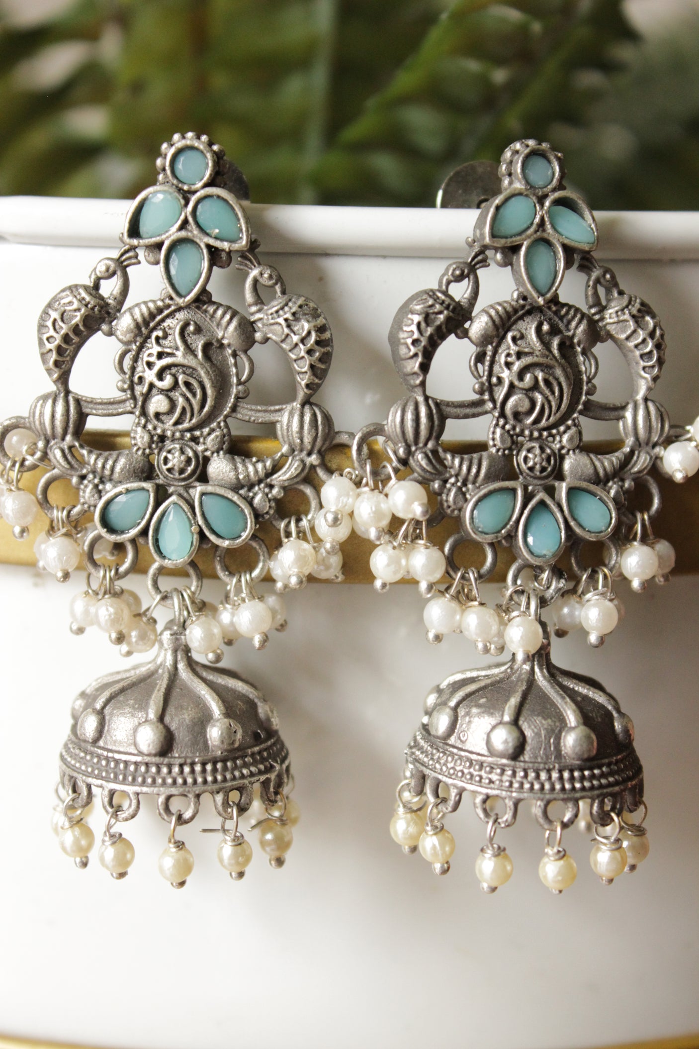 Intricately Detailed Turquoise Glass Stones Embedded Brass Statement Dangler Earrings Accentuated with White Beads