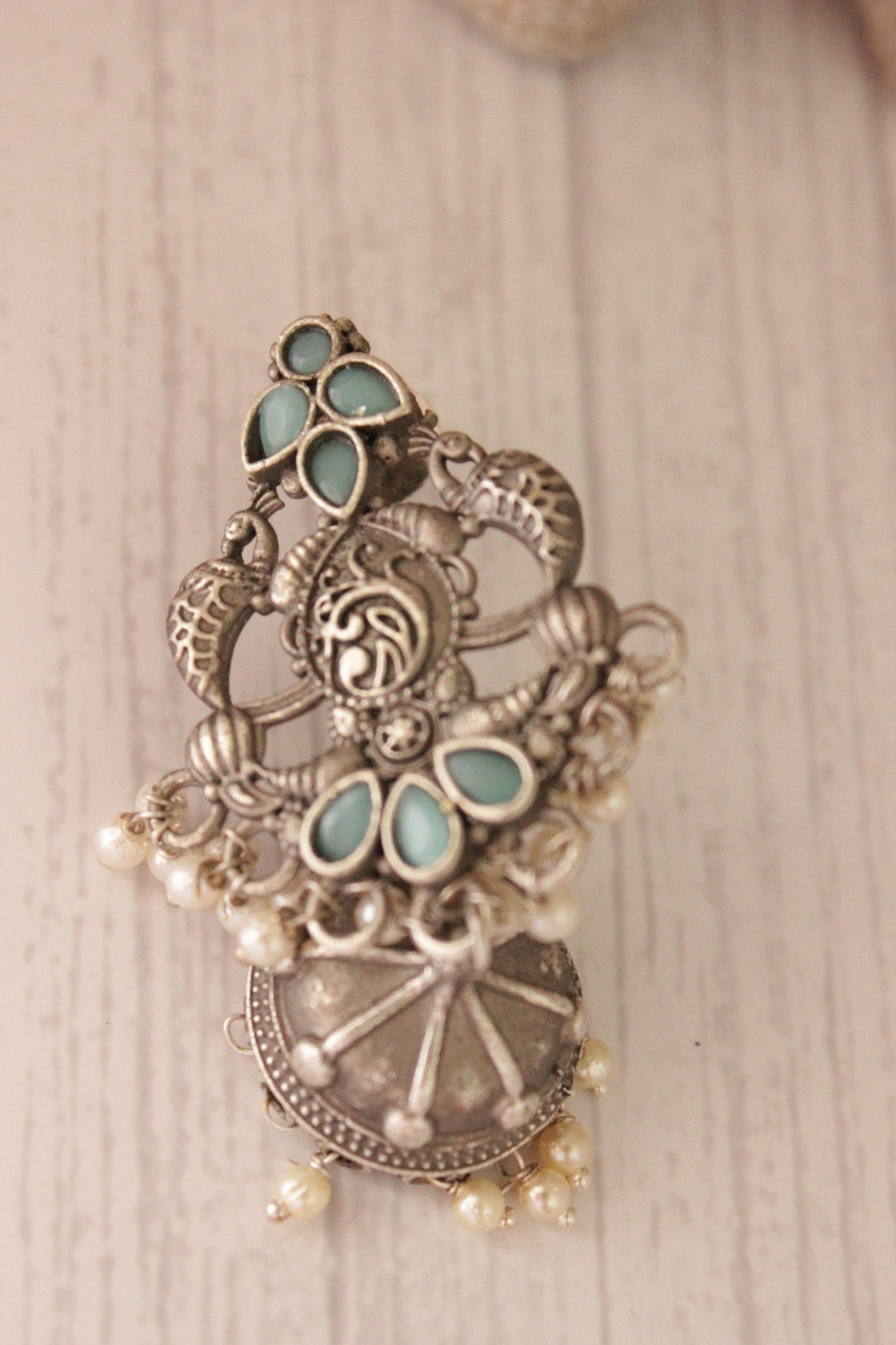 Intricately Detailed Turquoise Glass Stones Embedded Brass Statement Dangler Earrings Accentuated with White Beads