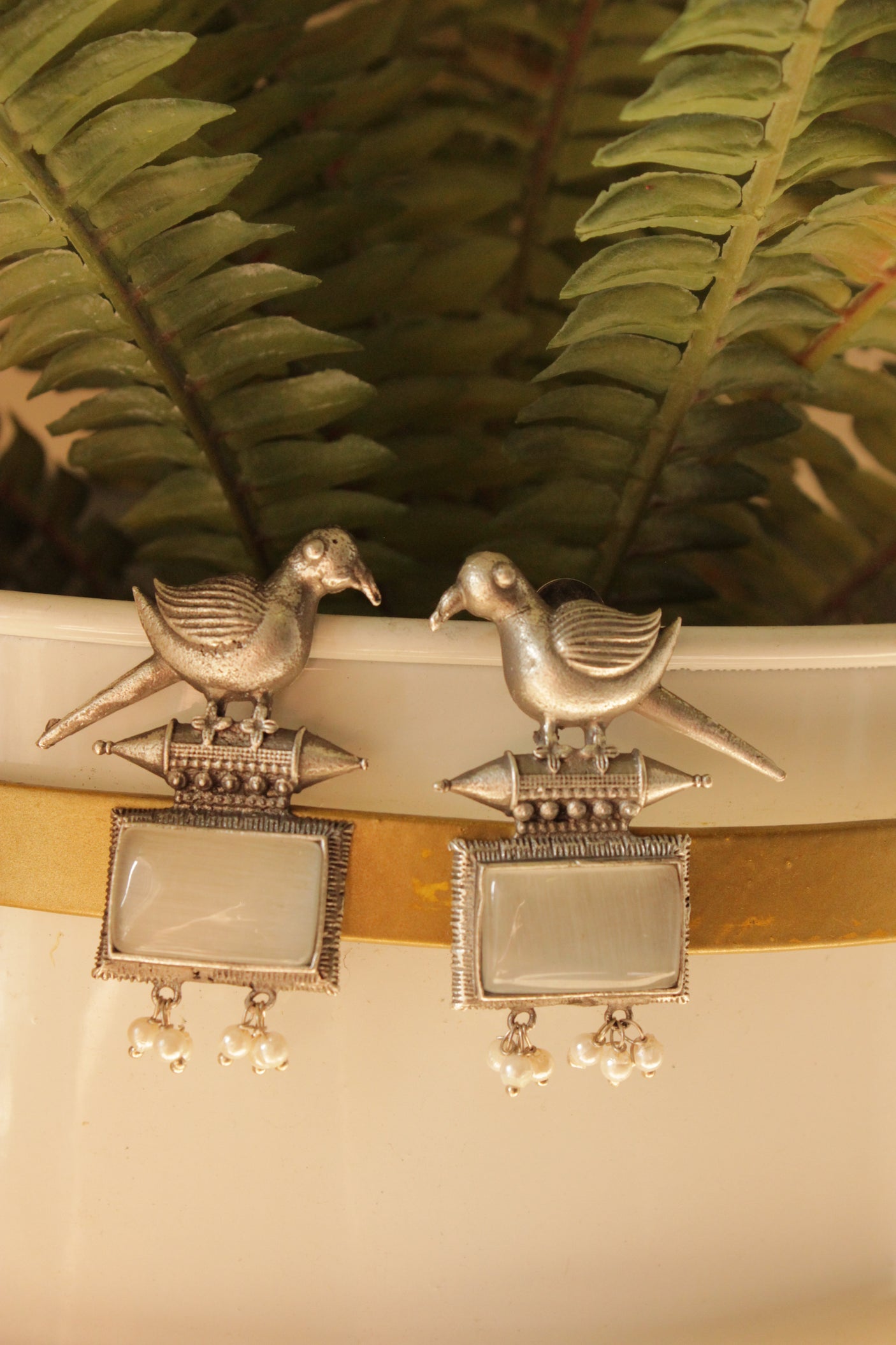 Peacock Motif Ivory Glass Stone Embedded Silver Finish Brass Dangler Earrings