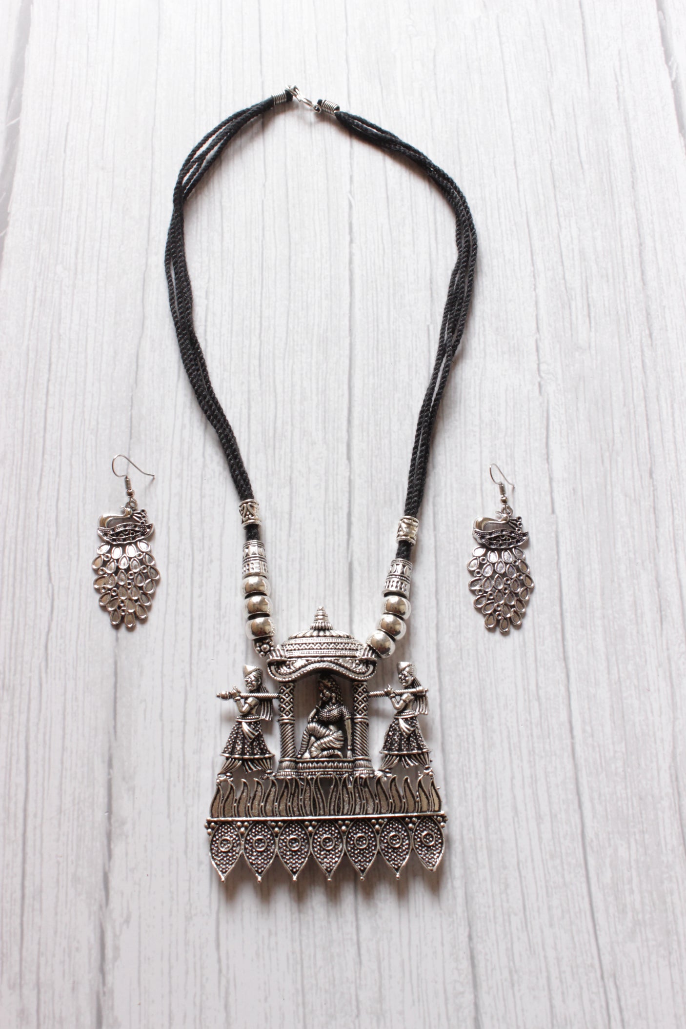 Bride in a Palki Intricately Detailed Silver Finish Necklace Set