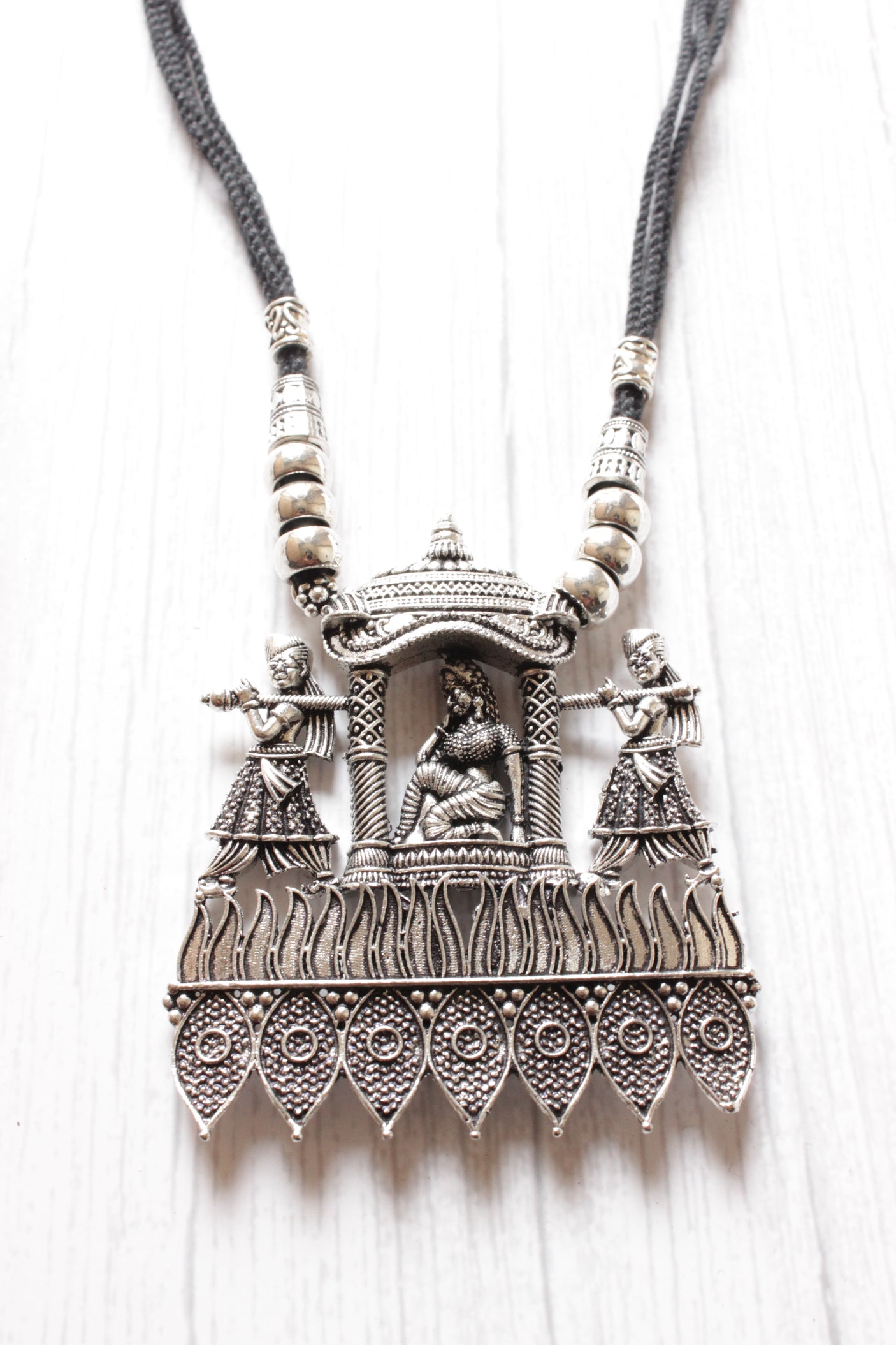Bride in a Palki Intricately Detailed Silver Finish Necklace Set