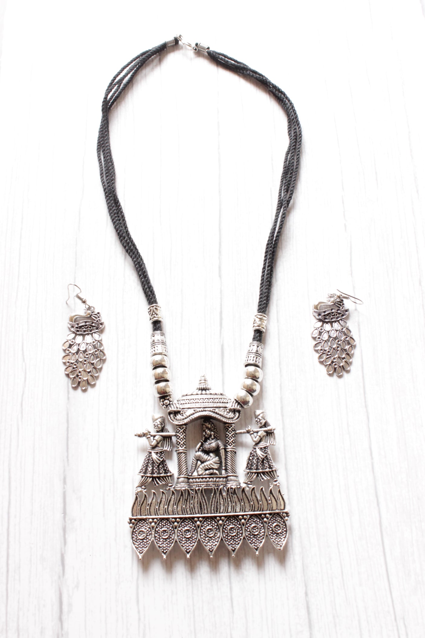 Bride in a Palki Intricately Detailed Silver Finish Necklace Set