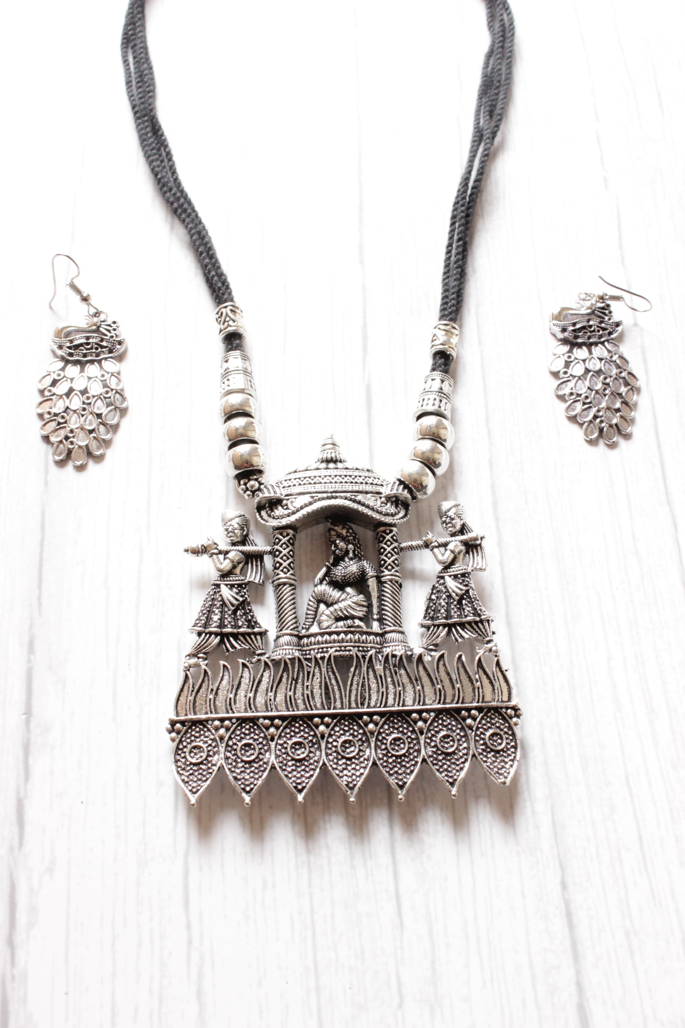 Bride in a Palki Intricately Detailed Silver Finish Necklace Set