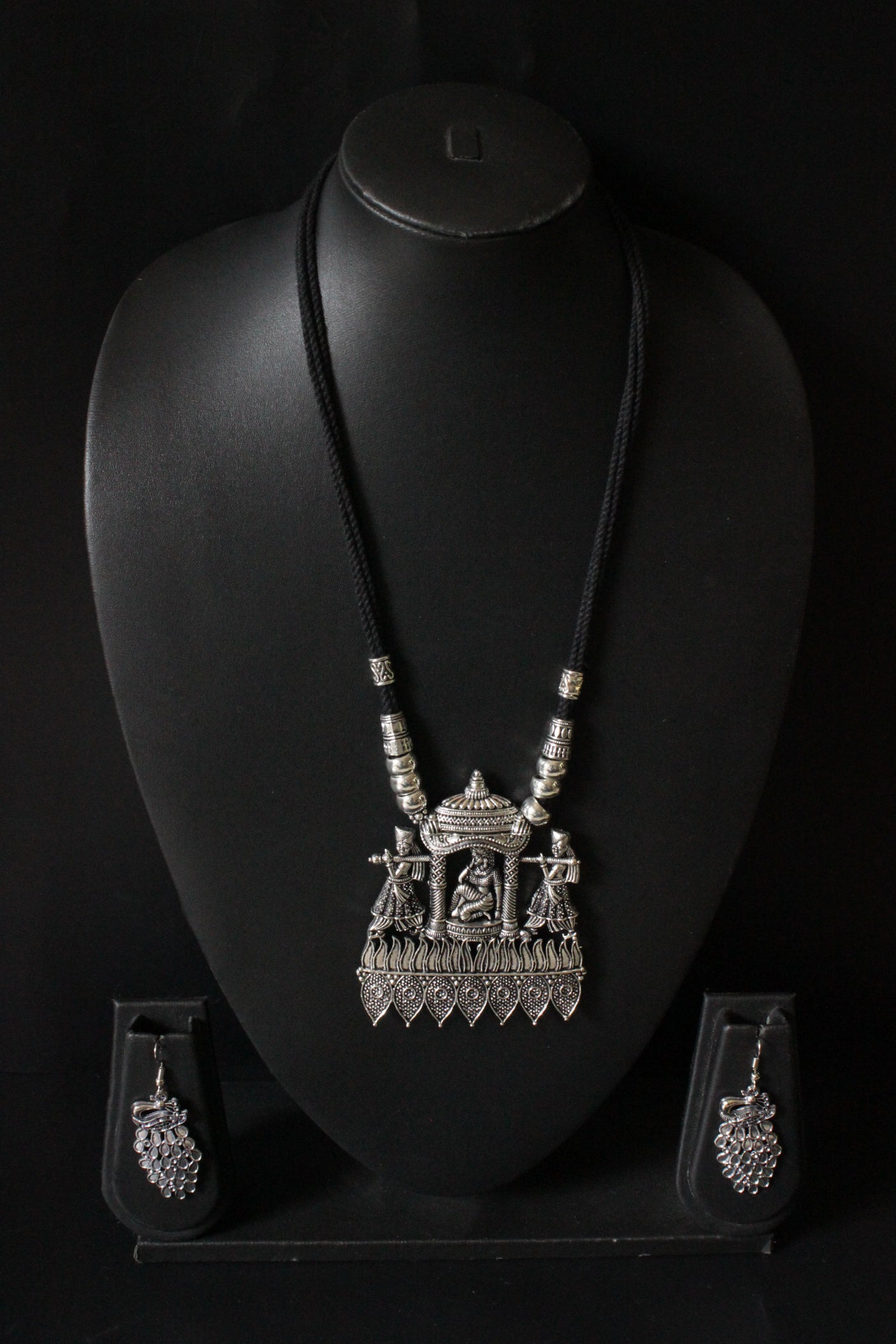 Bride in a Palki Intricately Detailed Silver Finish Necklace Set