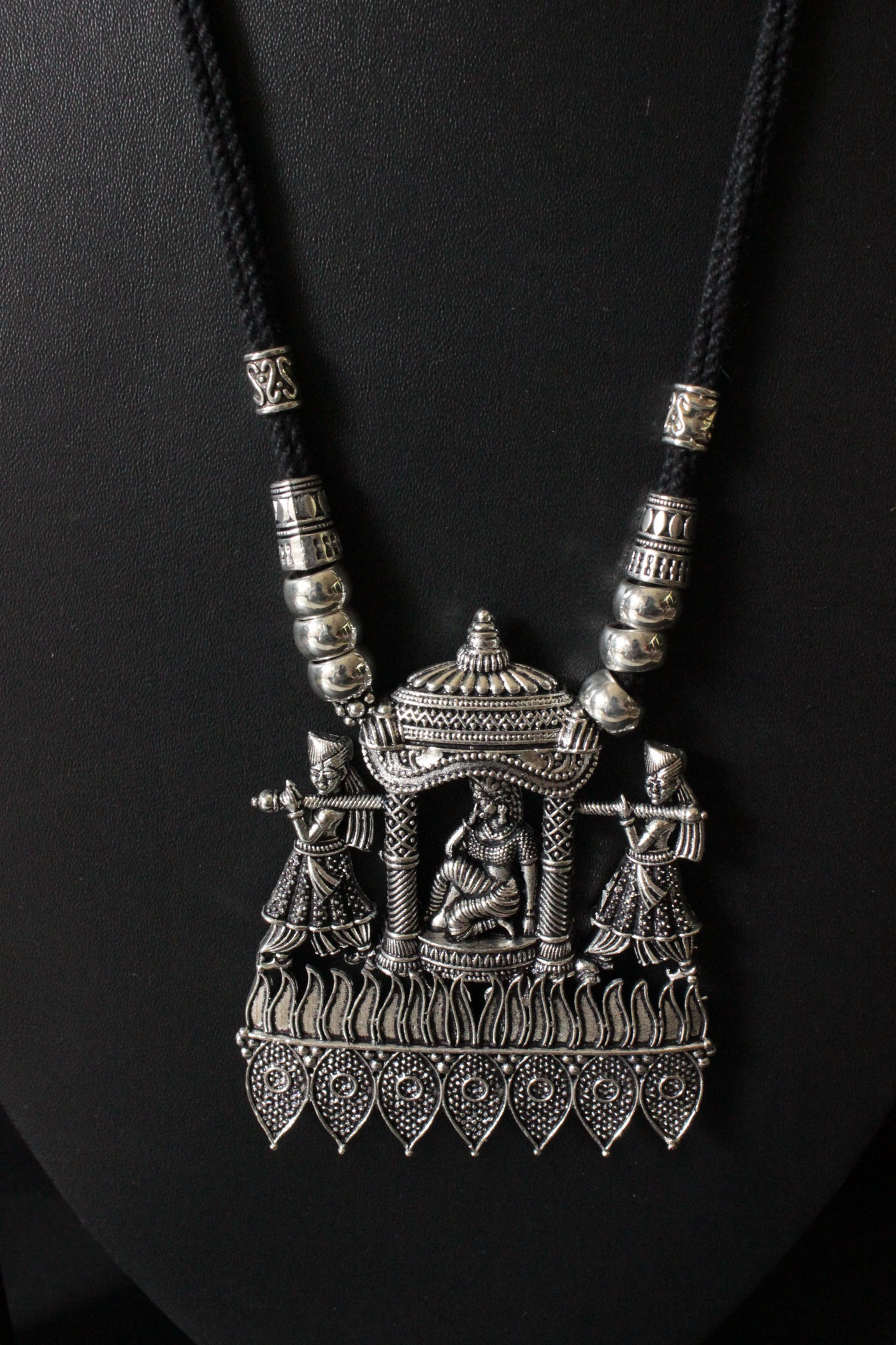 Bride in a Palki Intricately Detailed Silver Finish Necklace Set