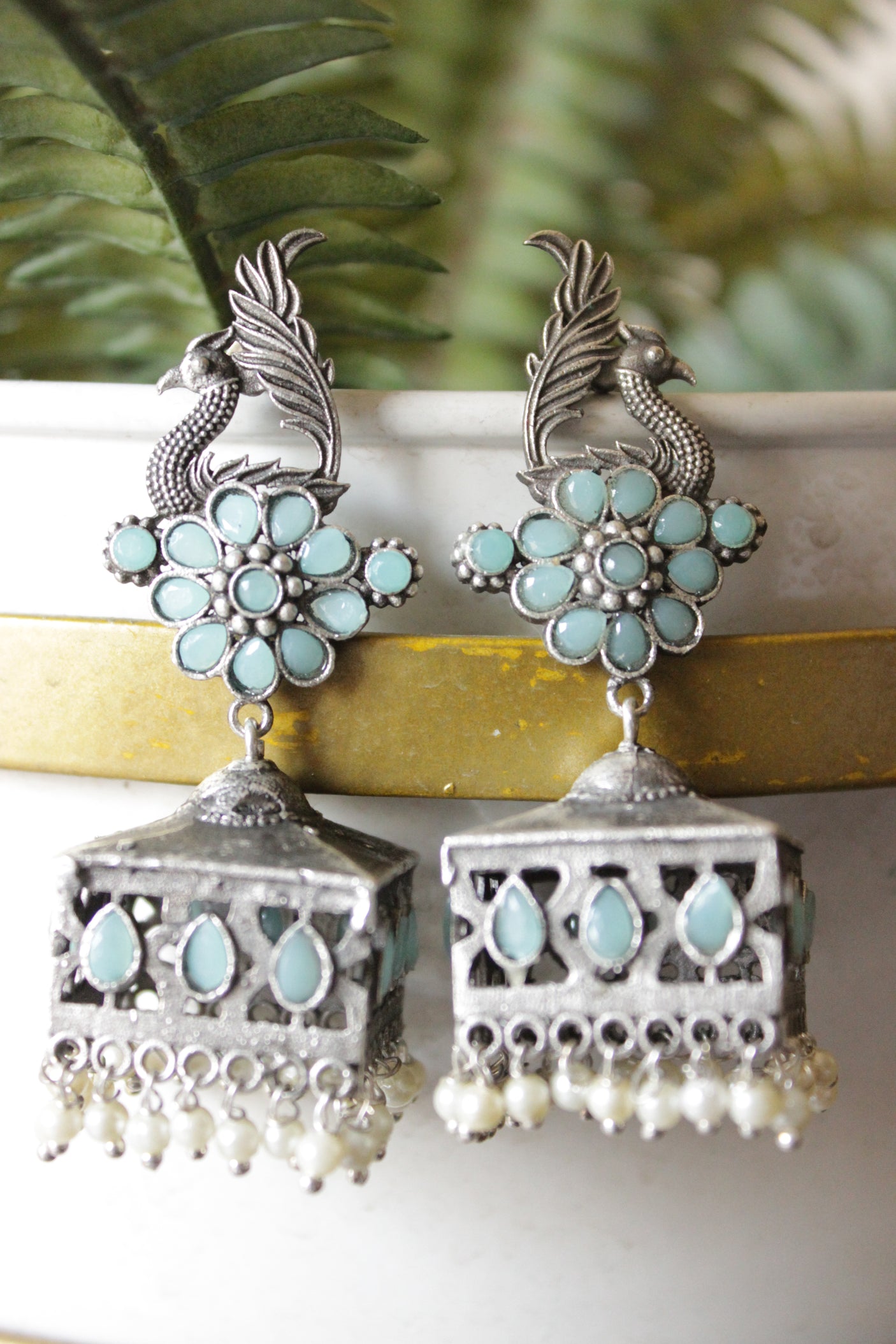 Turquoise Glass Stones Embedded Premium Oxidised Finish Peacock Motif Square Jhumka Earrings