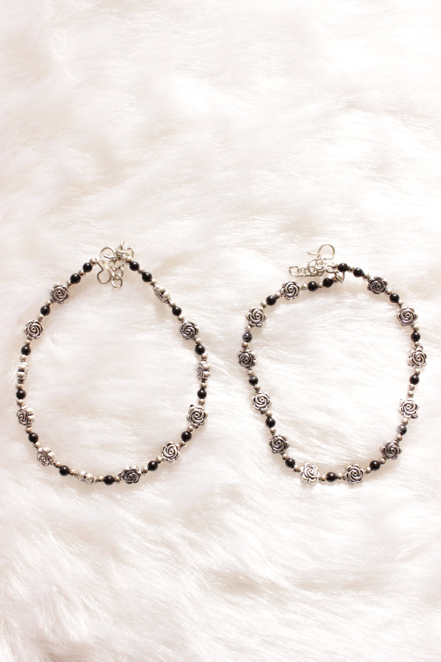 Silver Finish Flower Motif Charms Intertwined with Black Beads Set of 2 Anklets