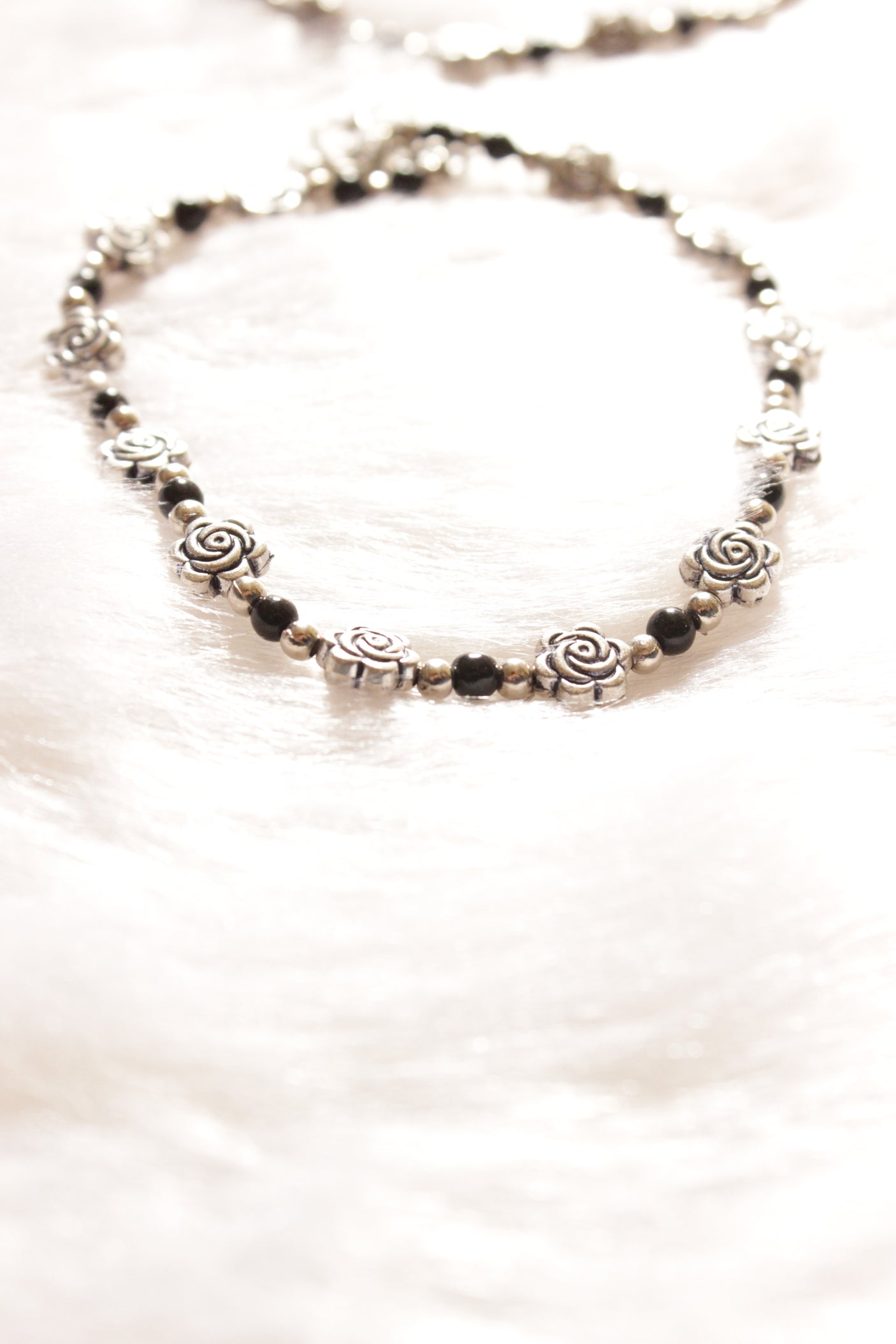 Silver Finish Flower Motif Charms Intertwined with Black Beads Set of 2 Anklets