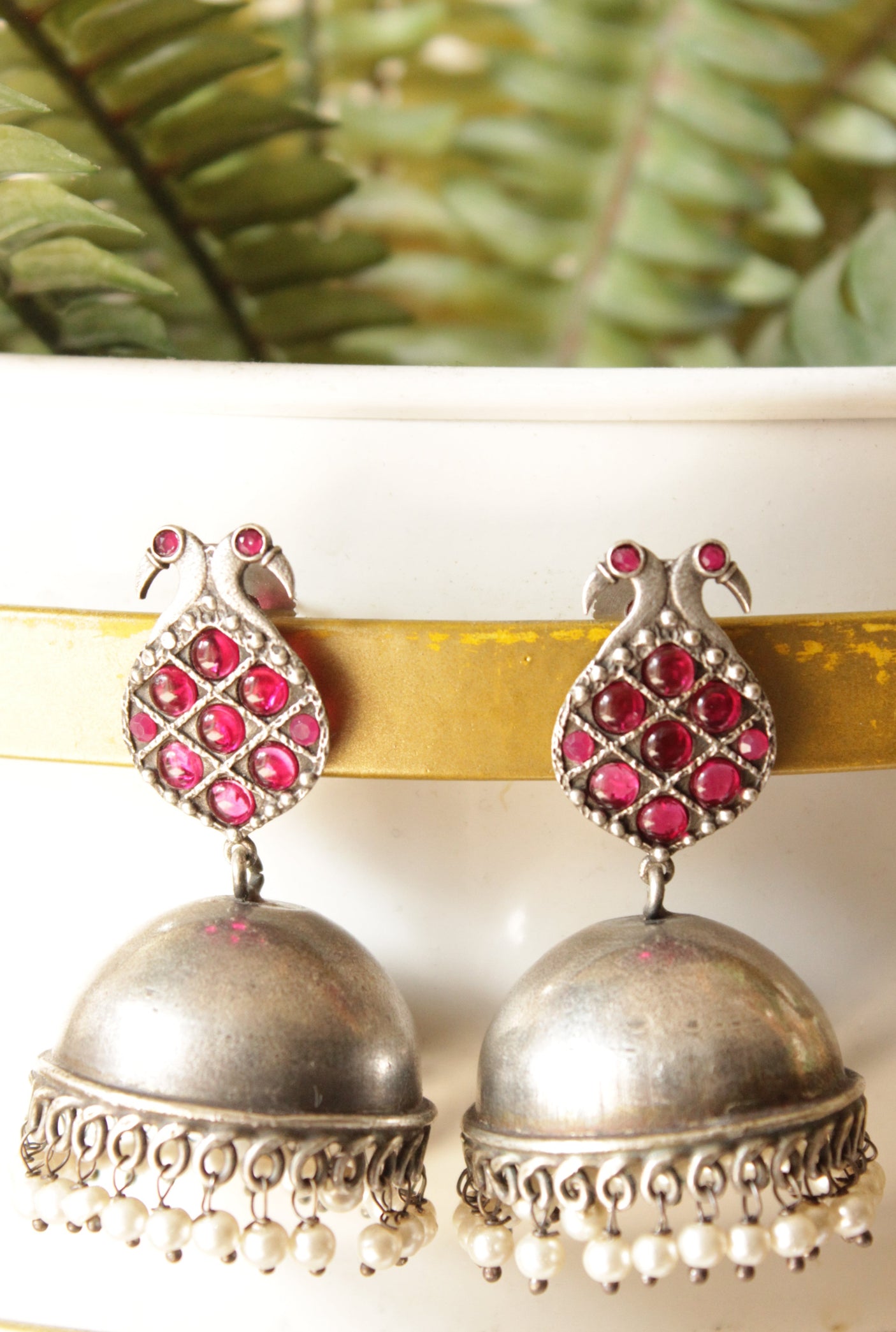 Fuchsia Glass Stones Embedded Peacock Motif Premium Oxidised Finish Brass Jhumka Earrings