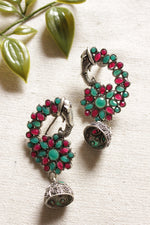 Load image into Gallery viewer, Oxidised Finish Green &amp; Red Glass Stones Embedded Peacock Shape Ethnic Jhumka Earrings
