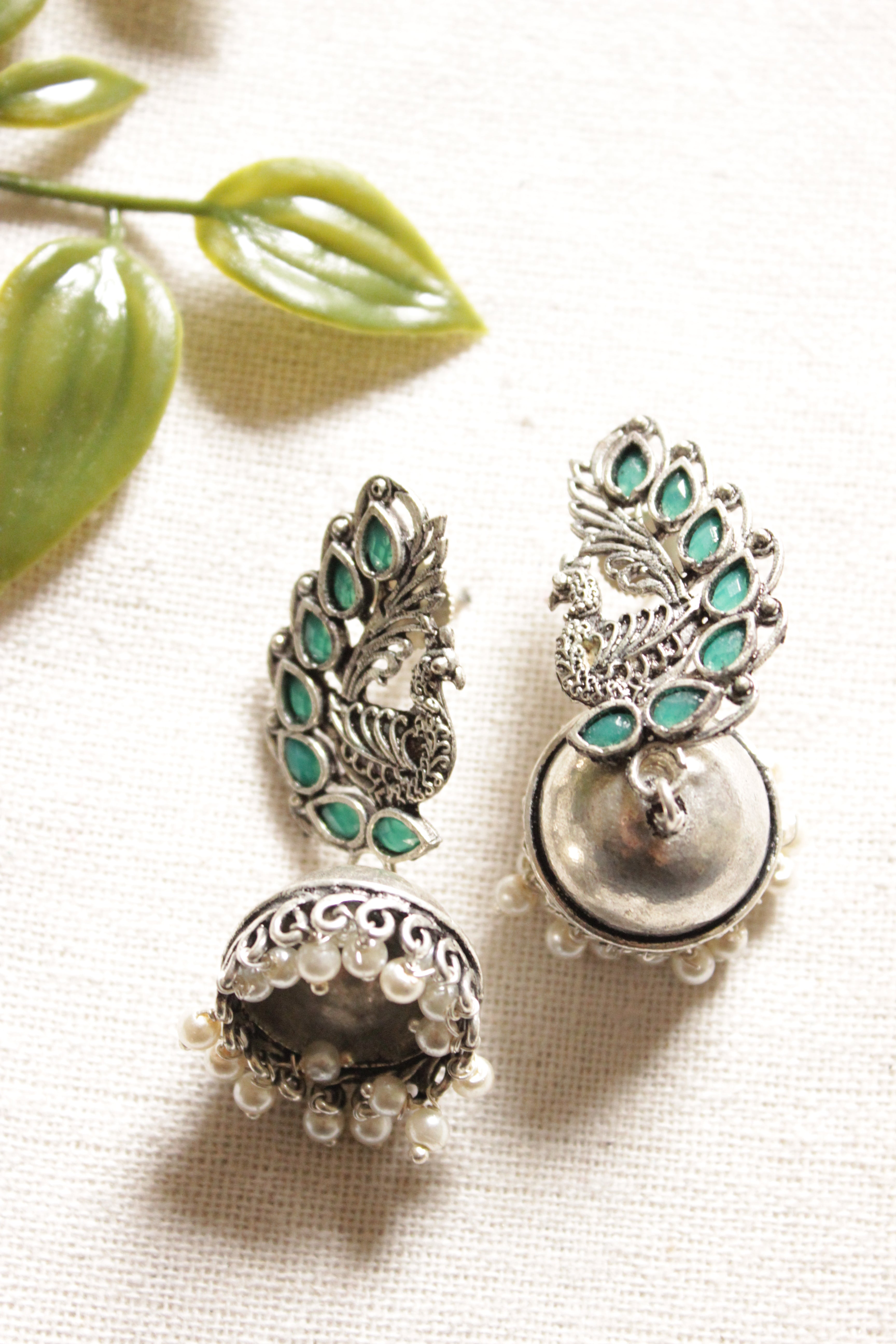 Peacock Shape Oxidised Finish Green Glass Stones Embedded Jhumka Earrings
