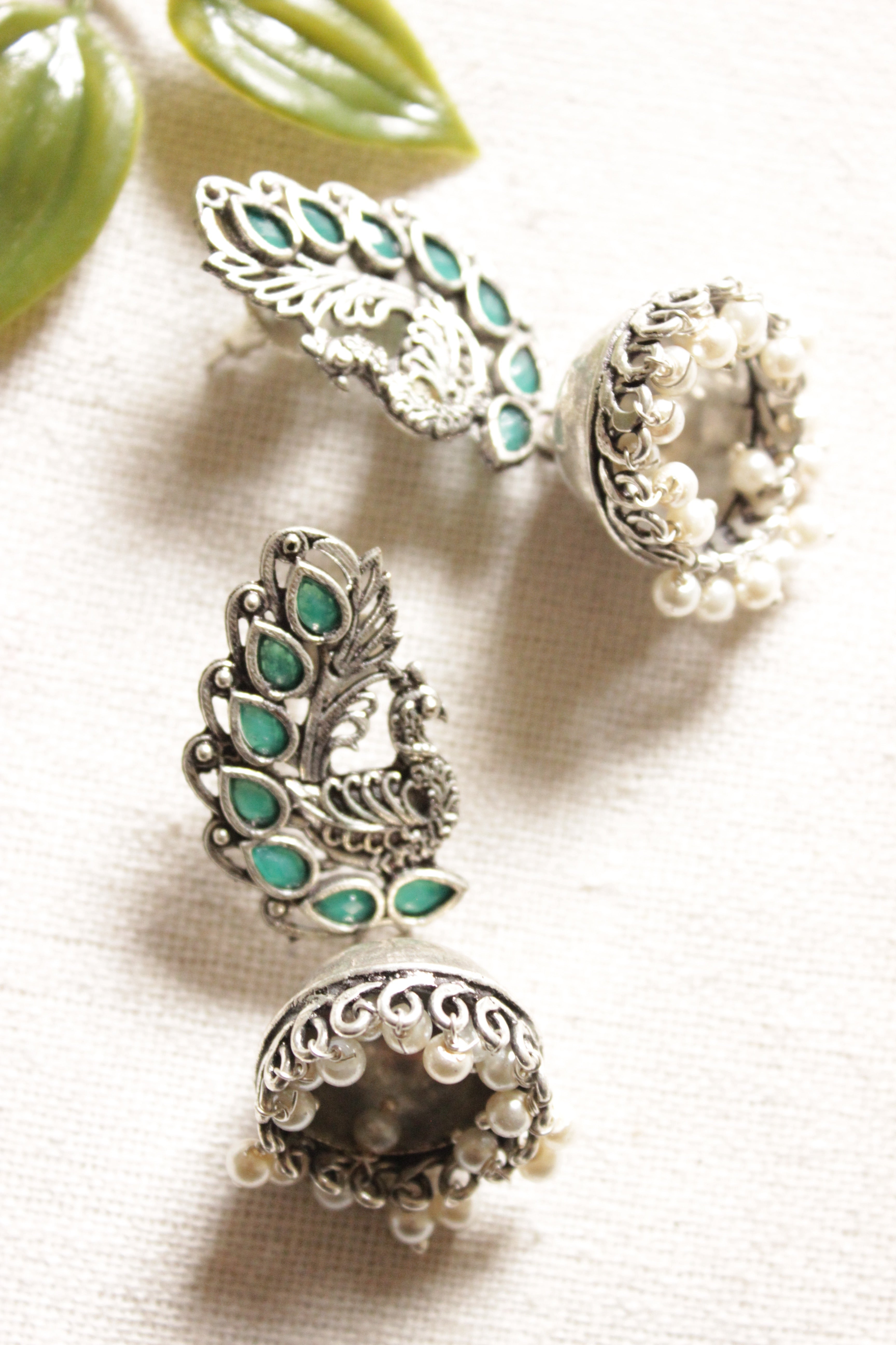 Peacock Shape Oxidised Finish Green Glass Stones Embedded Jhumka Earrings