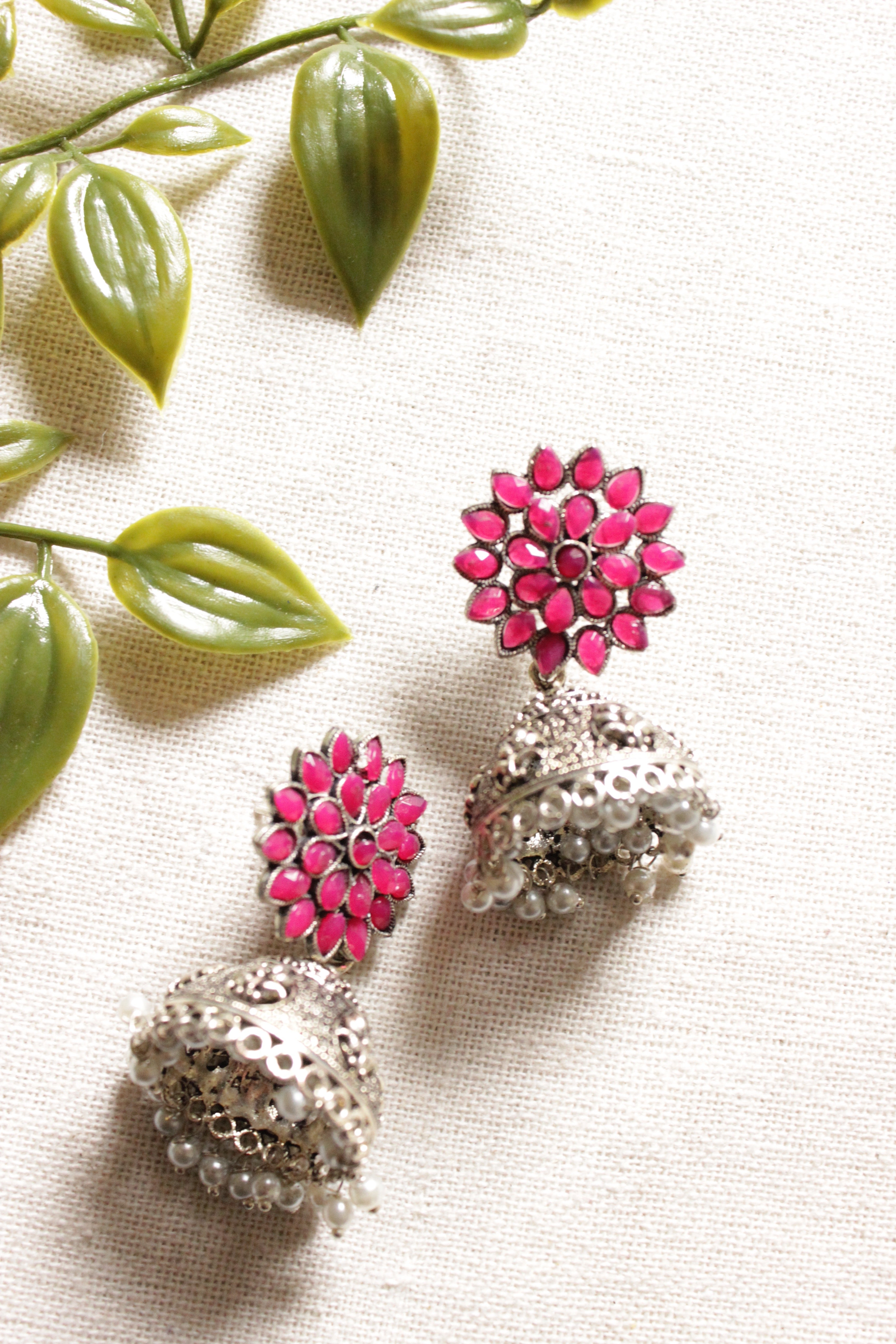 Flower Shape Silver Finish Pink Glass Stones Embedded Jhumka Earrings