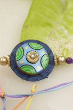 Load image into Gallery viewer, Fabric and Terracotta Clay Hand Painted Flower Motifs Rakhi

