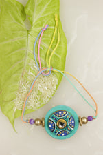 Load image into Gallery viewer, Fabric and Terracotta Clay Turquoise Hand Painted Rakhi
