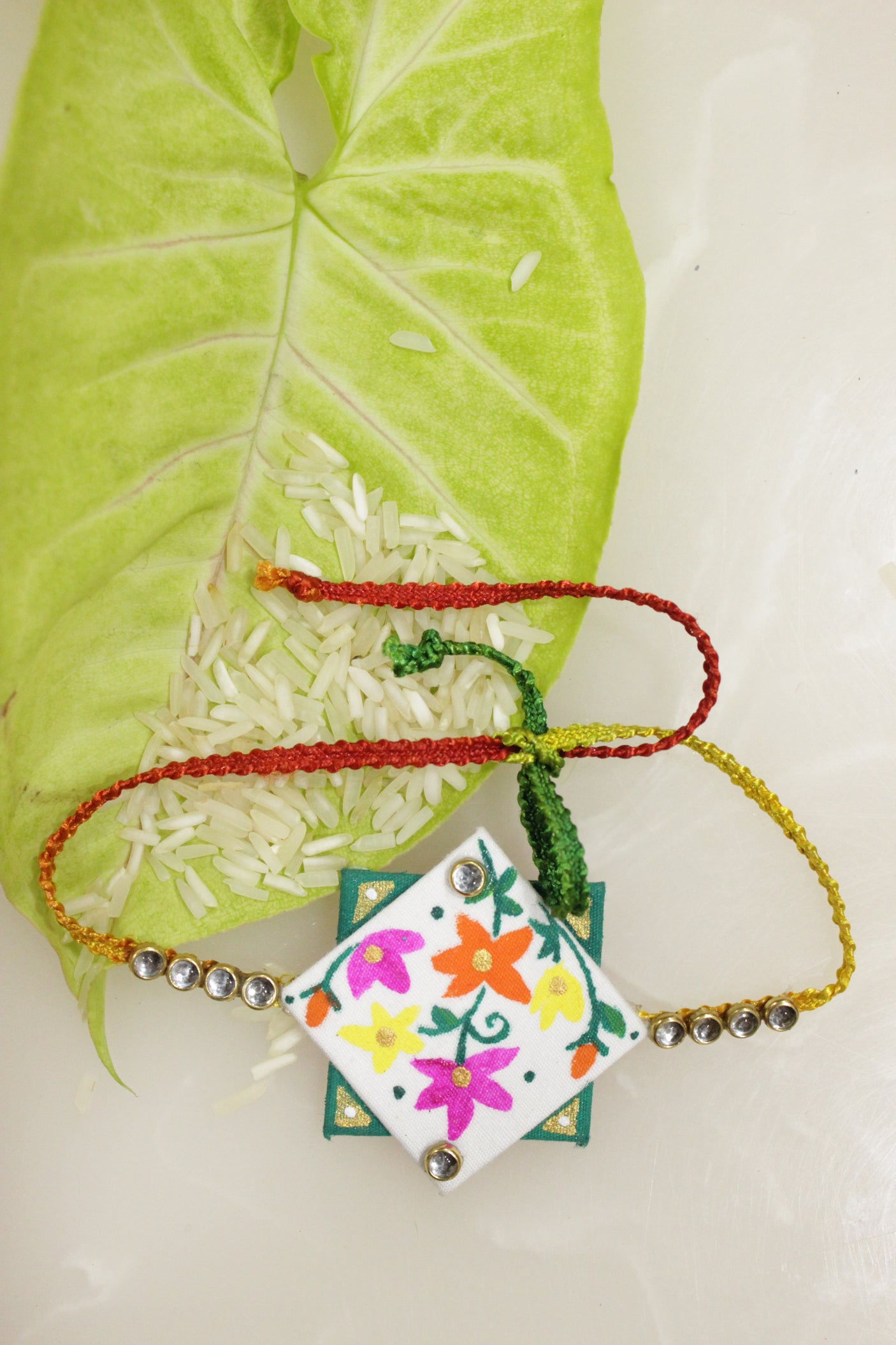 White & Green Fabric Fabric Flowers Hand Painted Rakhi