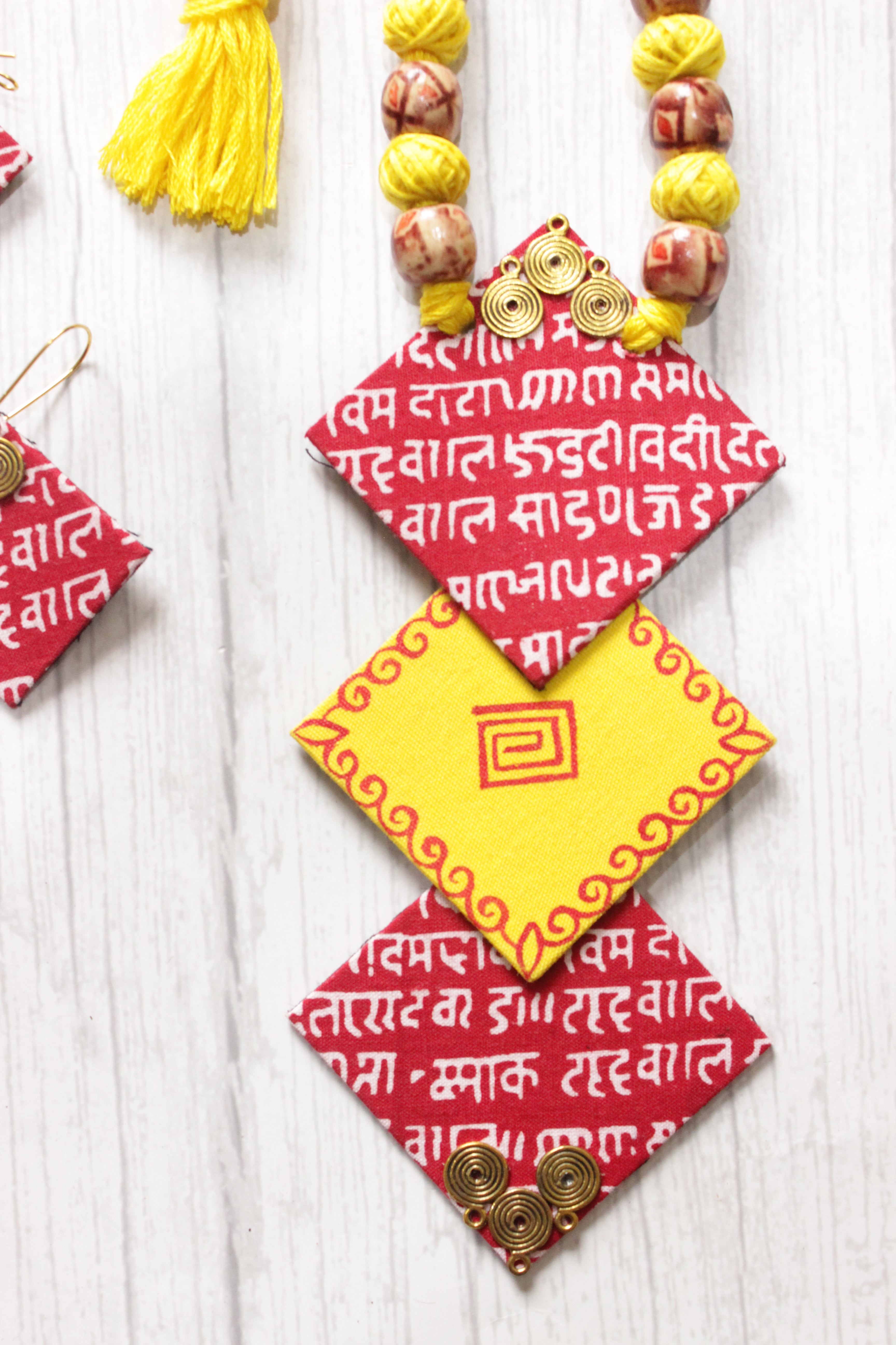 Mantra Printed 3 Layer Pendant Red & Yellow Fabric Necklace Set with Adjustable Thread Closure Necklace Set