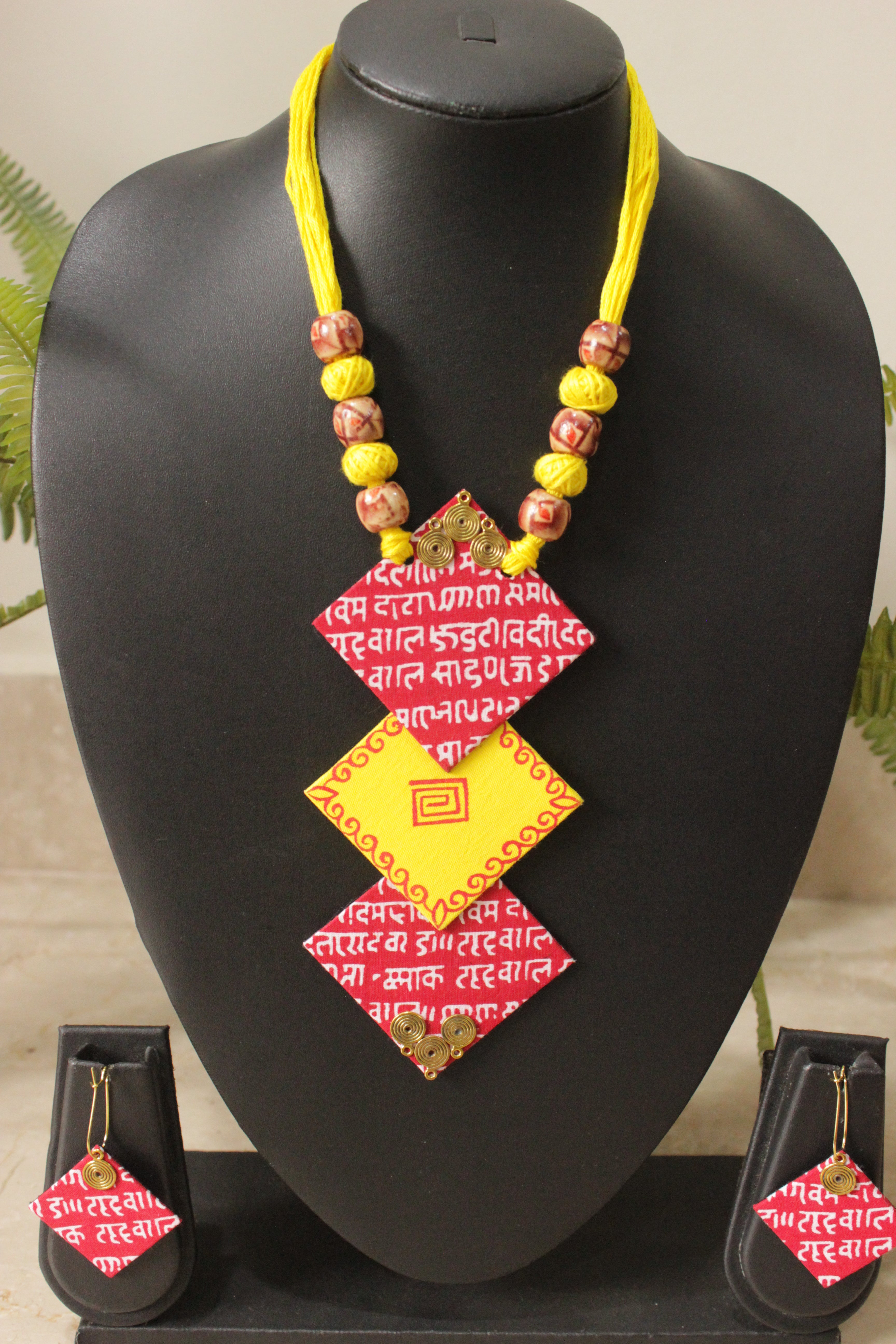 Mantra Printed 3 Layer Pendant Red & Yellow Fabric Necklace Set with Adjustable Thread Closure Necklace Set