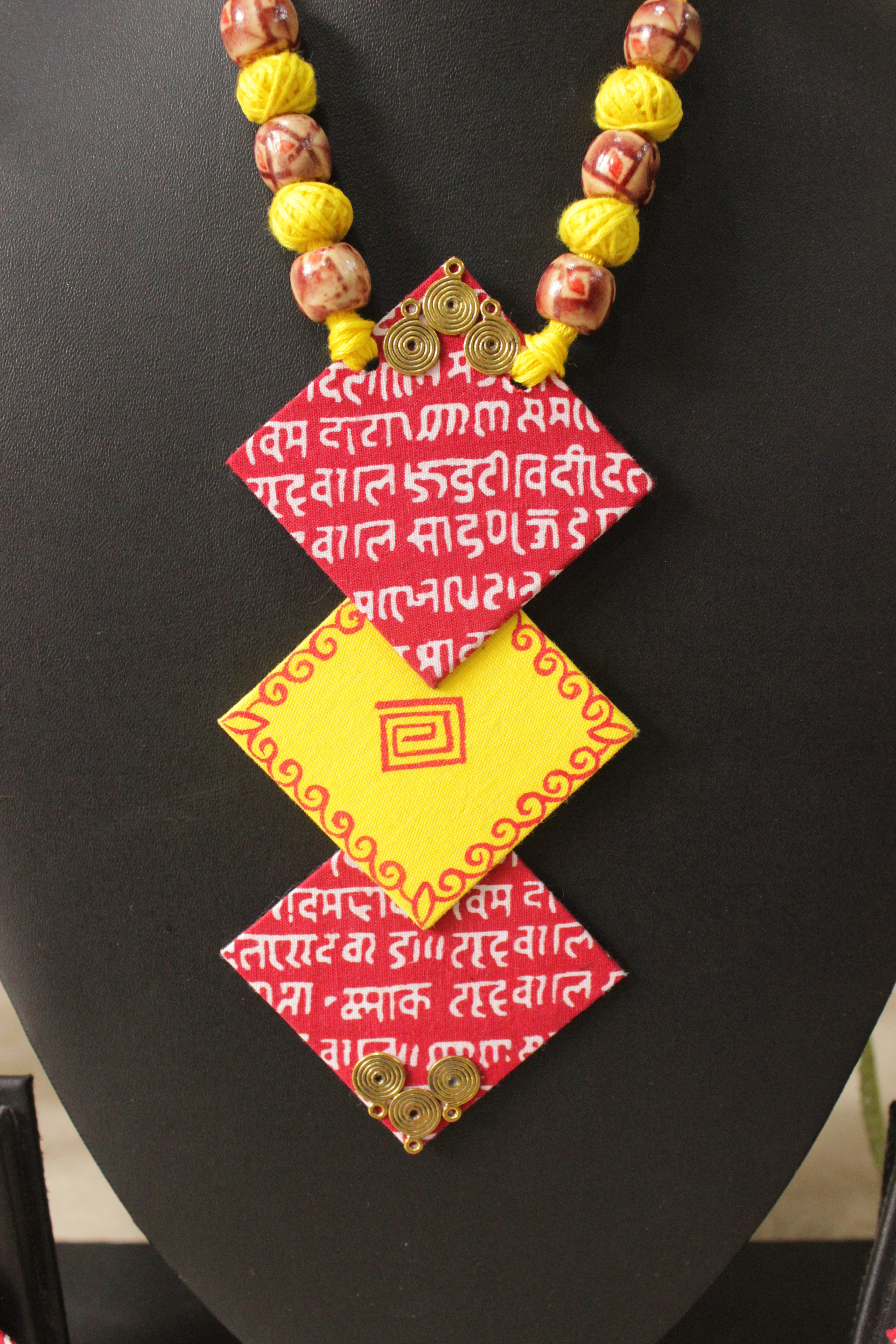 Mantra Printed 3 Layer Pendant Red & Yellow Fabric Necklace Set with Adjustable Thread Closure Necklace Set