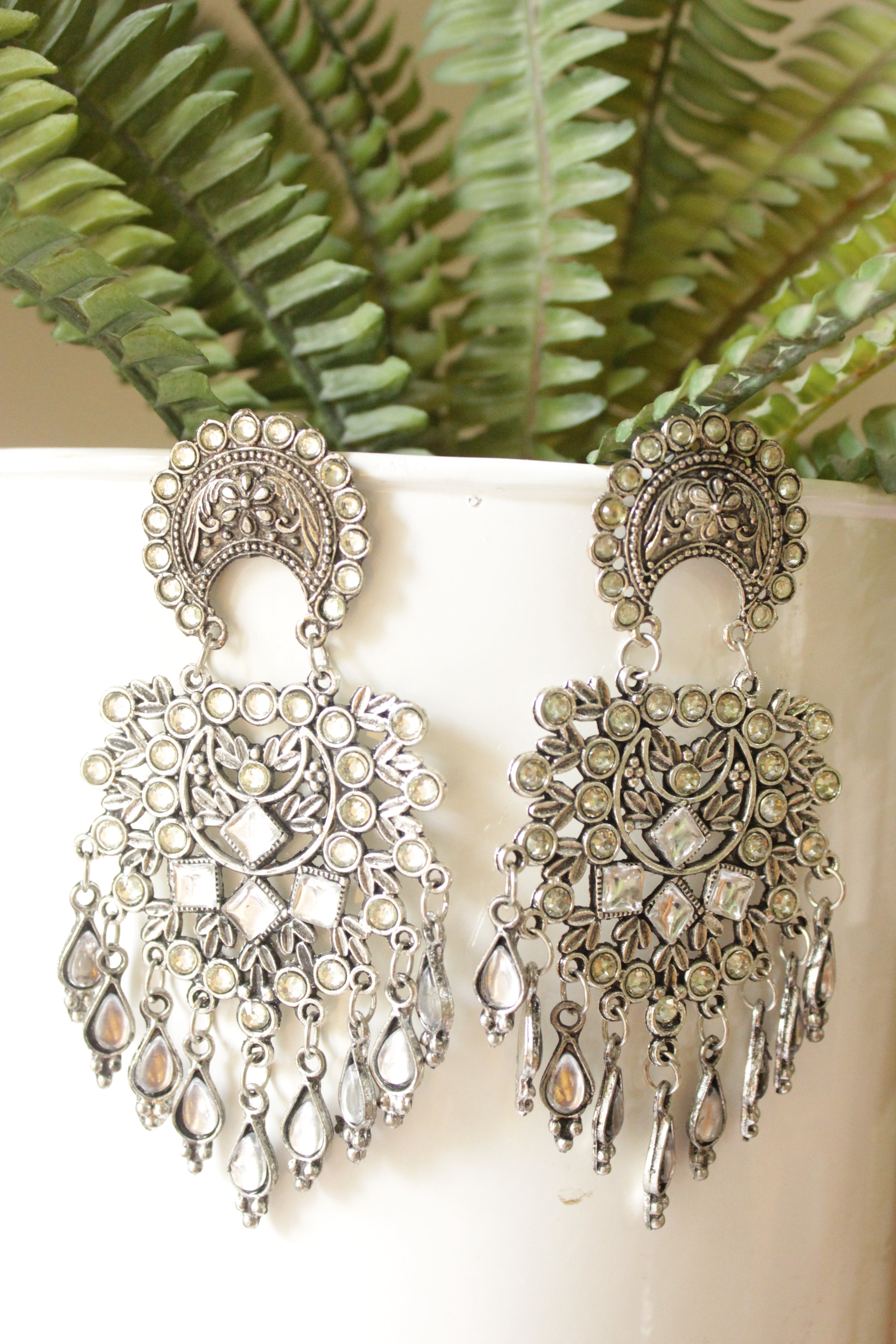 White Stones Embedded Intricately Detailed Silver Finish Statement Earrings